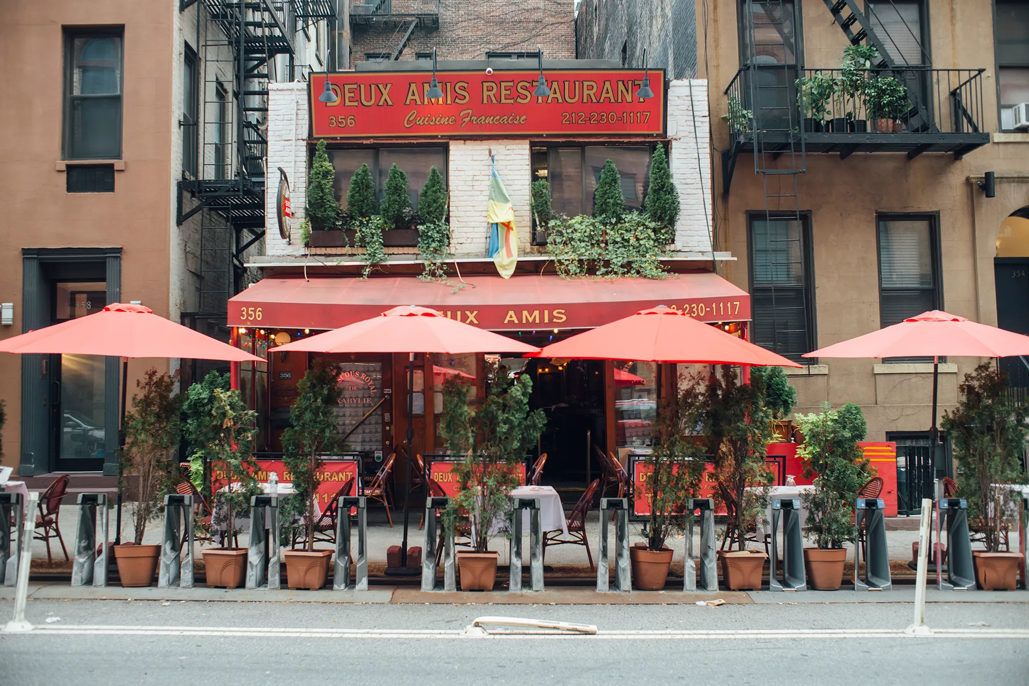 A brown building stands prominently against a clear sky, showcasing its solid structure and architectural design.