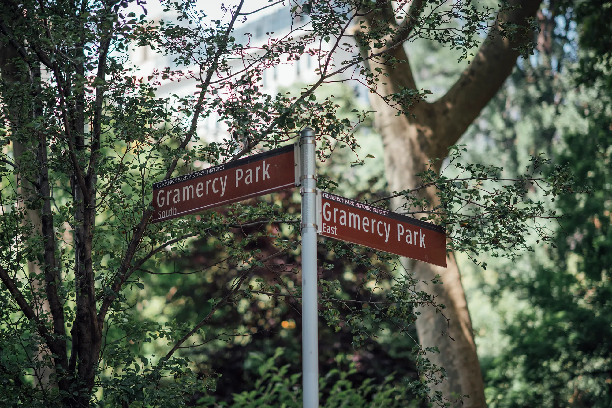 A street sign featuring two directional signs indicating different routes.