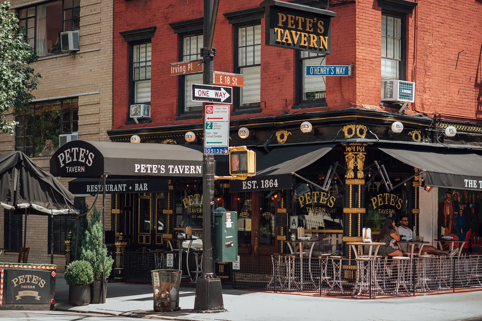 A red brick building with a classic architectural design and large windows.