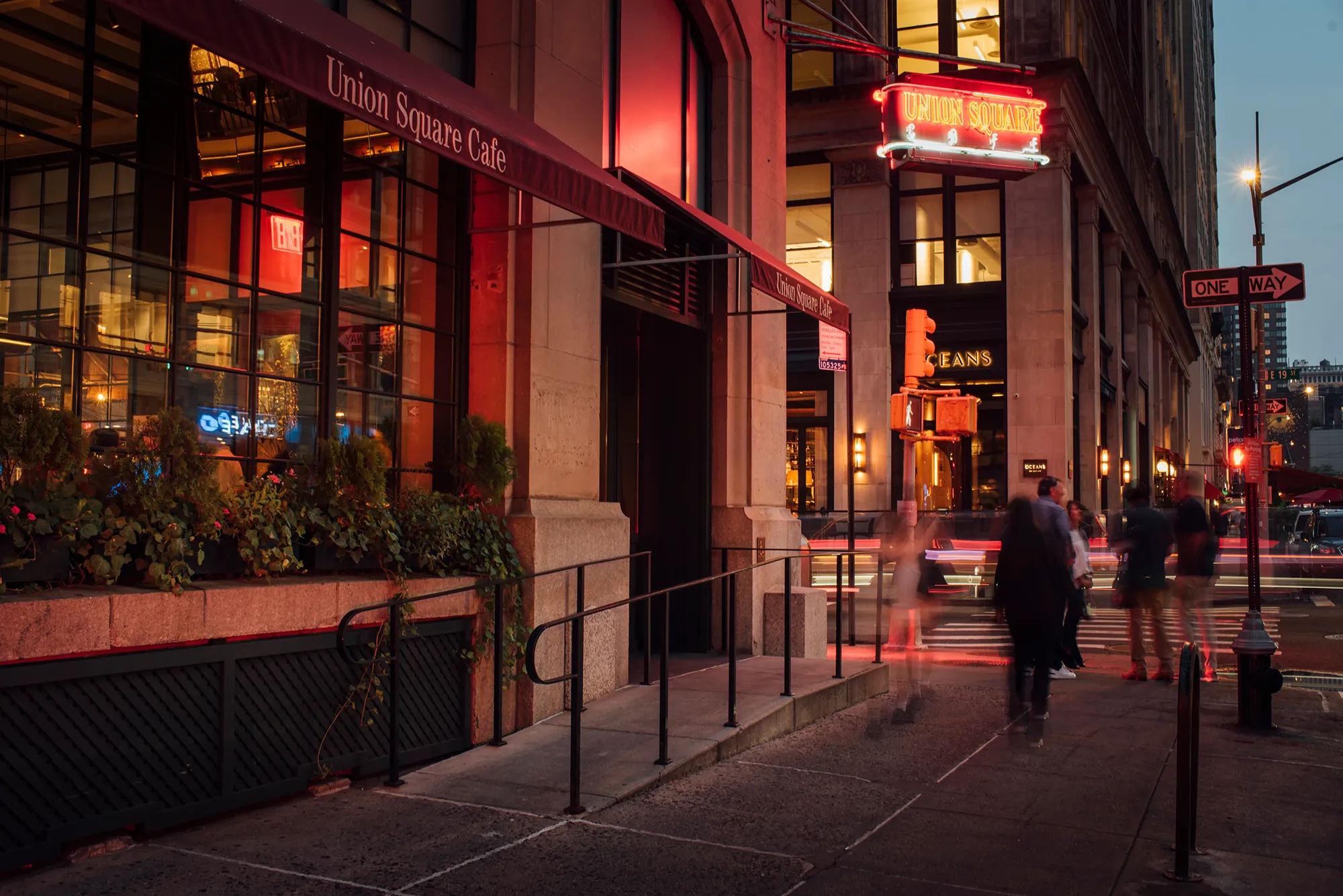 A building illuminated by a bright red neon sign, showcasing its vibrant nightlife atmosphere.
