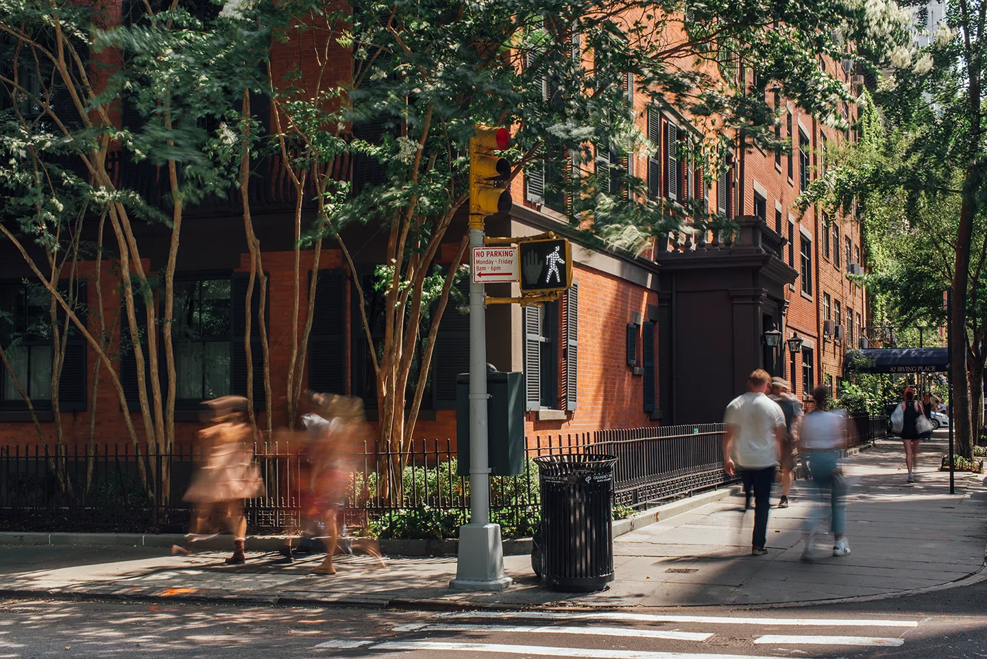 A diverse group of people walking together down a city street, engaged in conversation and enjoying their surroundings.