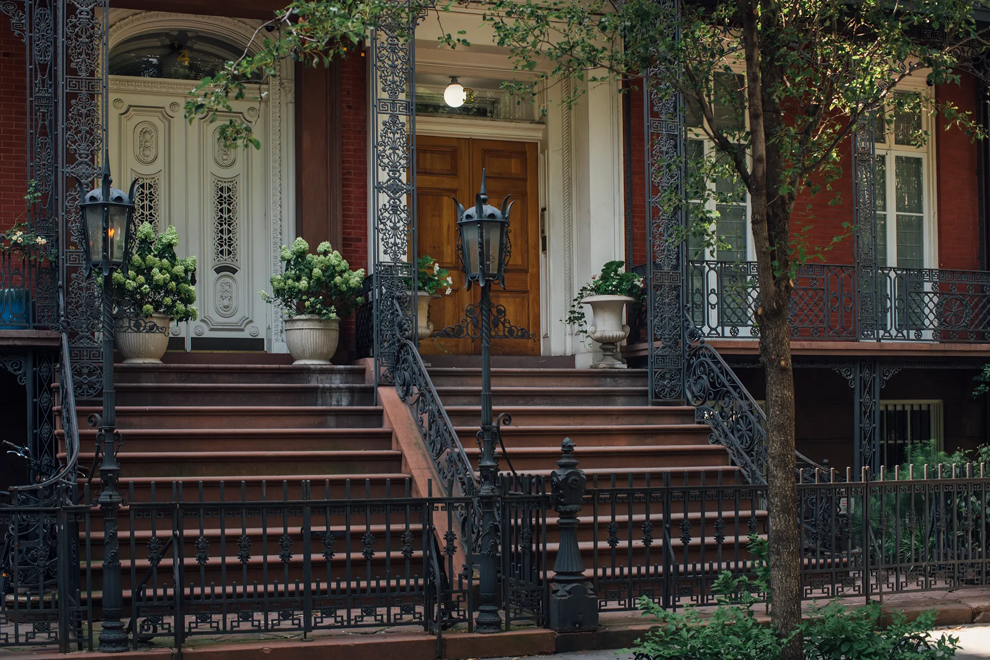 A decorative black wrought iron fence with intricate designs and vertical bars.