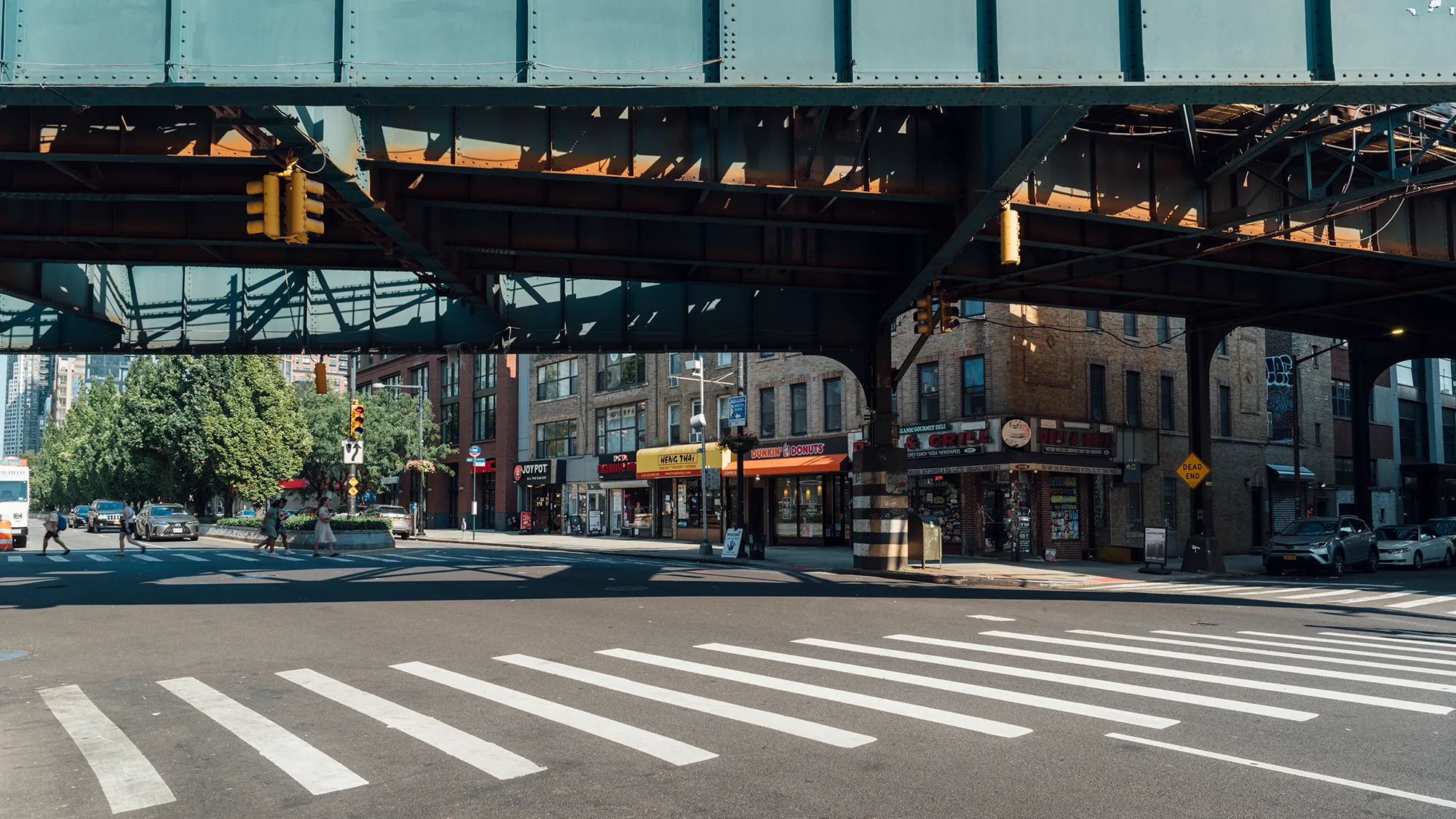 A street scene featuring a traffic light and a bridge in the background, showcasing urban infrastructure.
