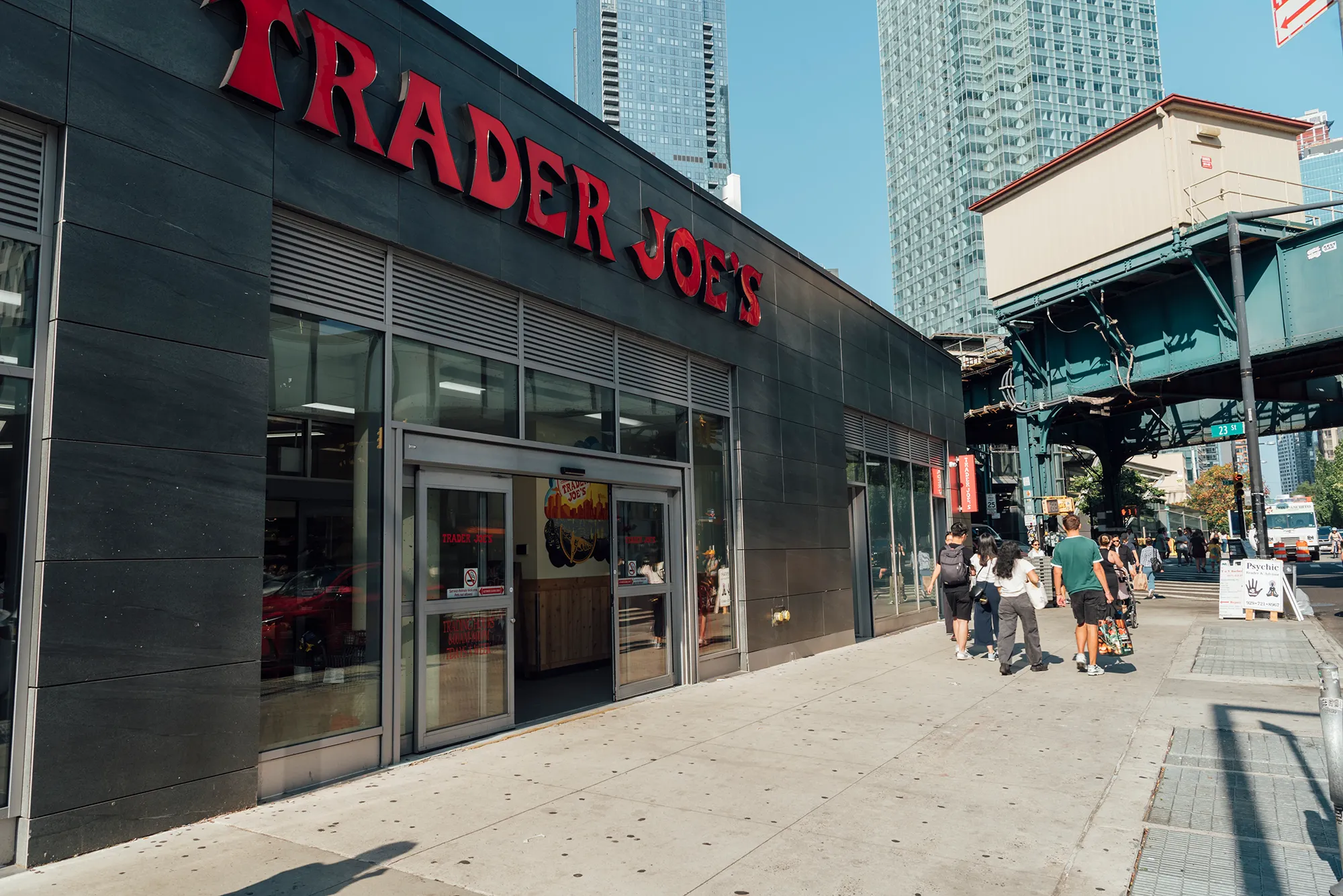 Trader Joe's storefront in New York City, featuring the iconic logo and bustling urban surroundings.