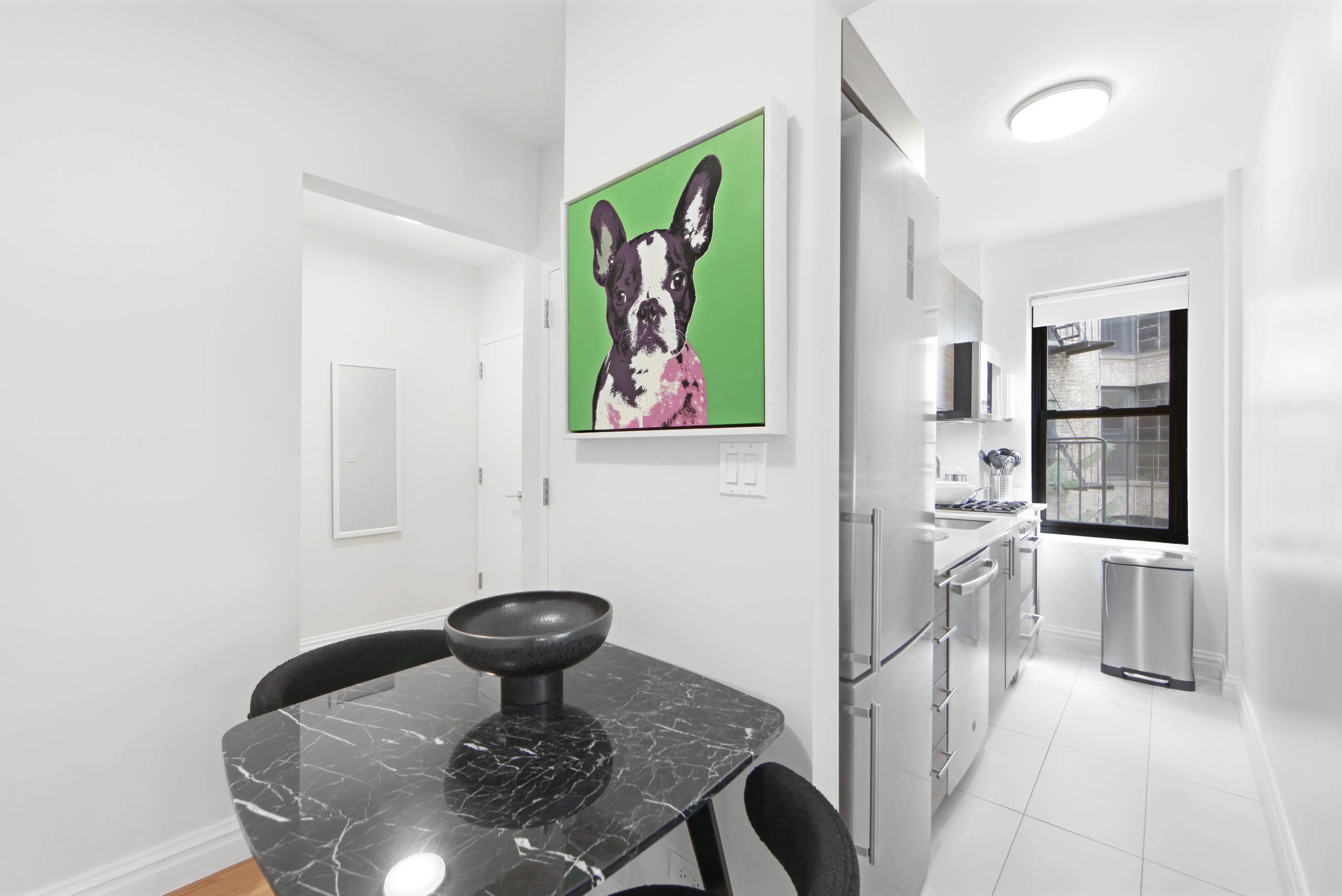 A kitchen featuring a black and white dog artwork displayed on the wall.