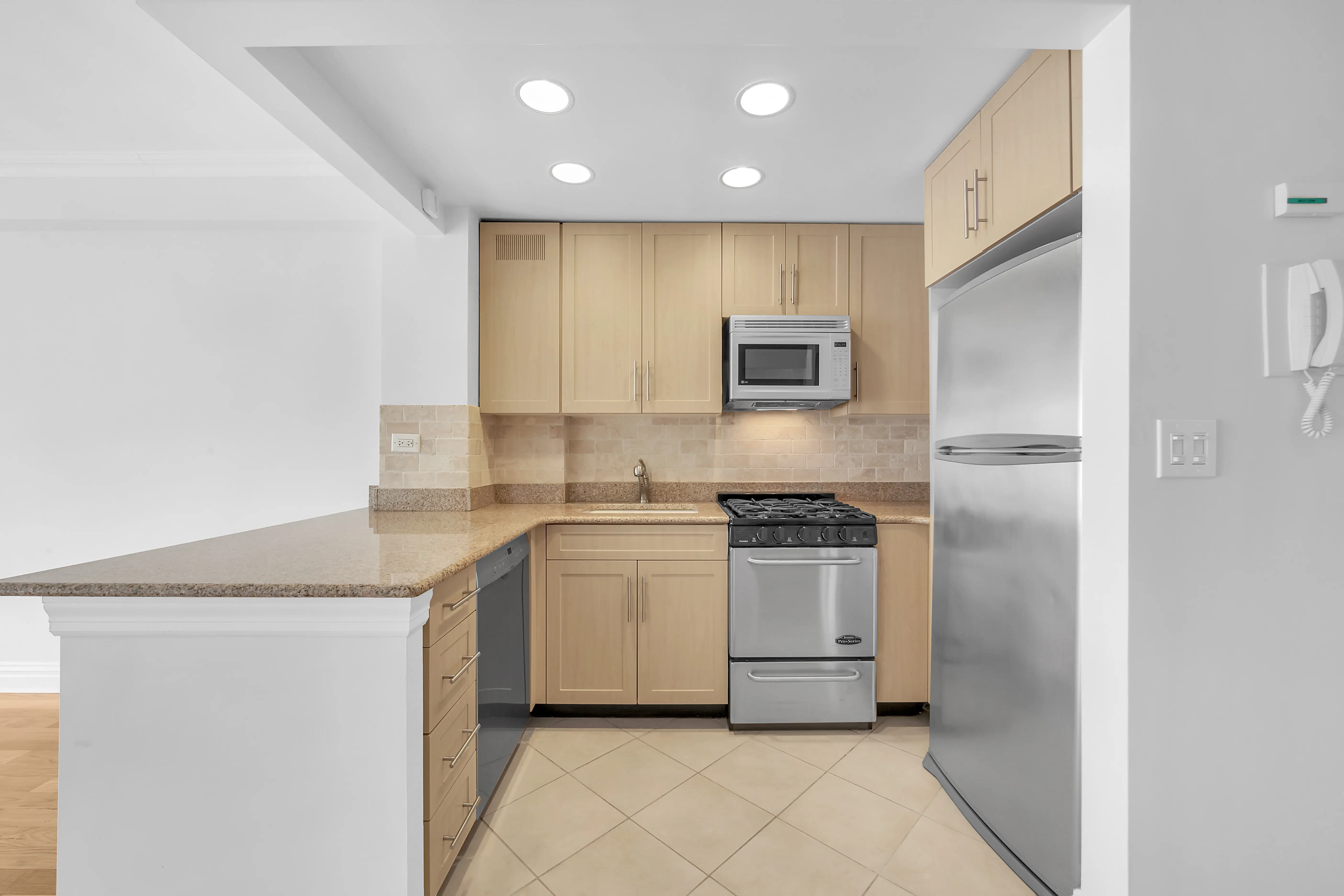 A modern kitchen featuring stainless steel appliances and elegant wooden cabinets.