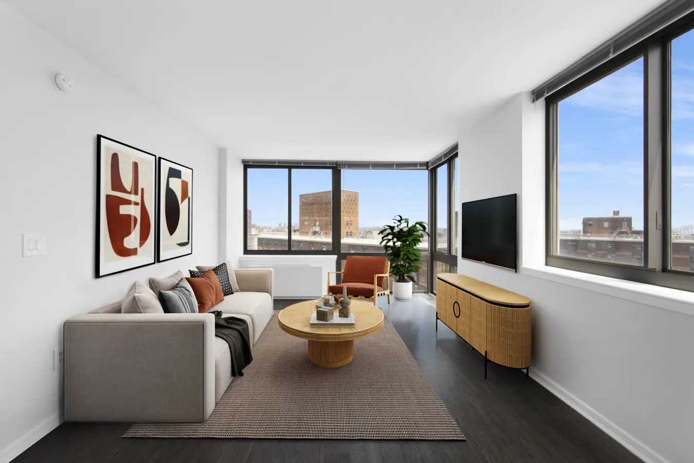 A stylish living room showcasing a couch, a coffee table, and windows that enhance the space with natural light.