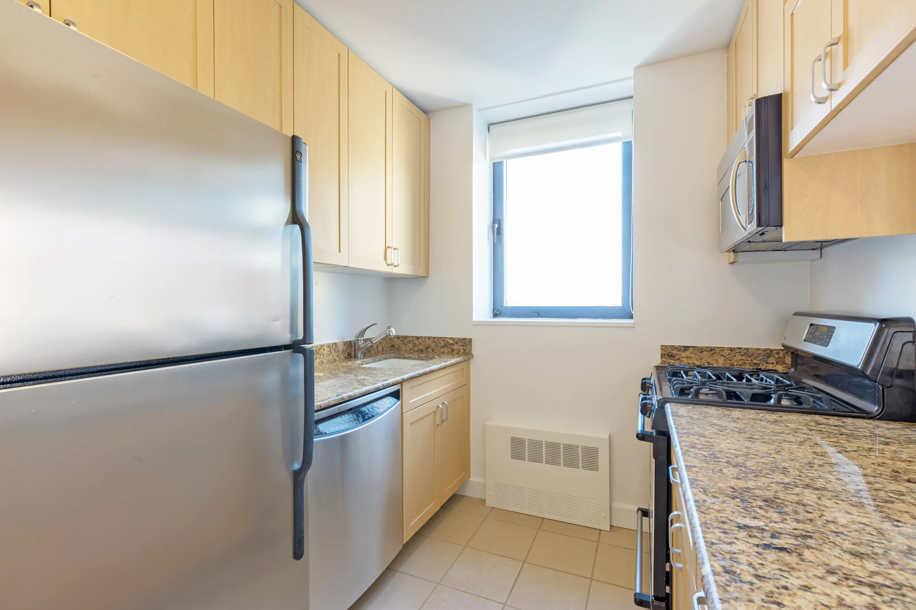 A stylish kitchen with sleek stainless steel appliances and polished granite countertops.