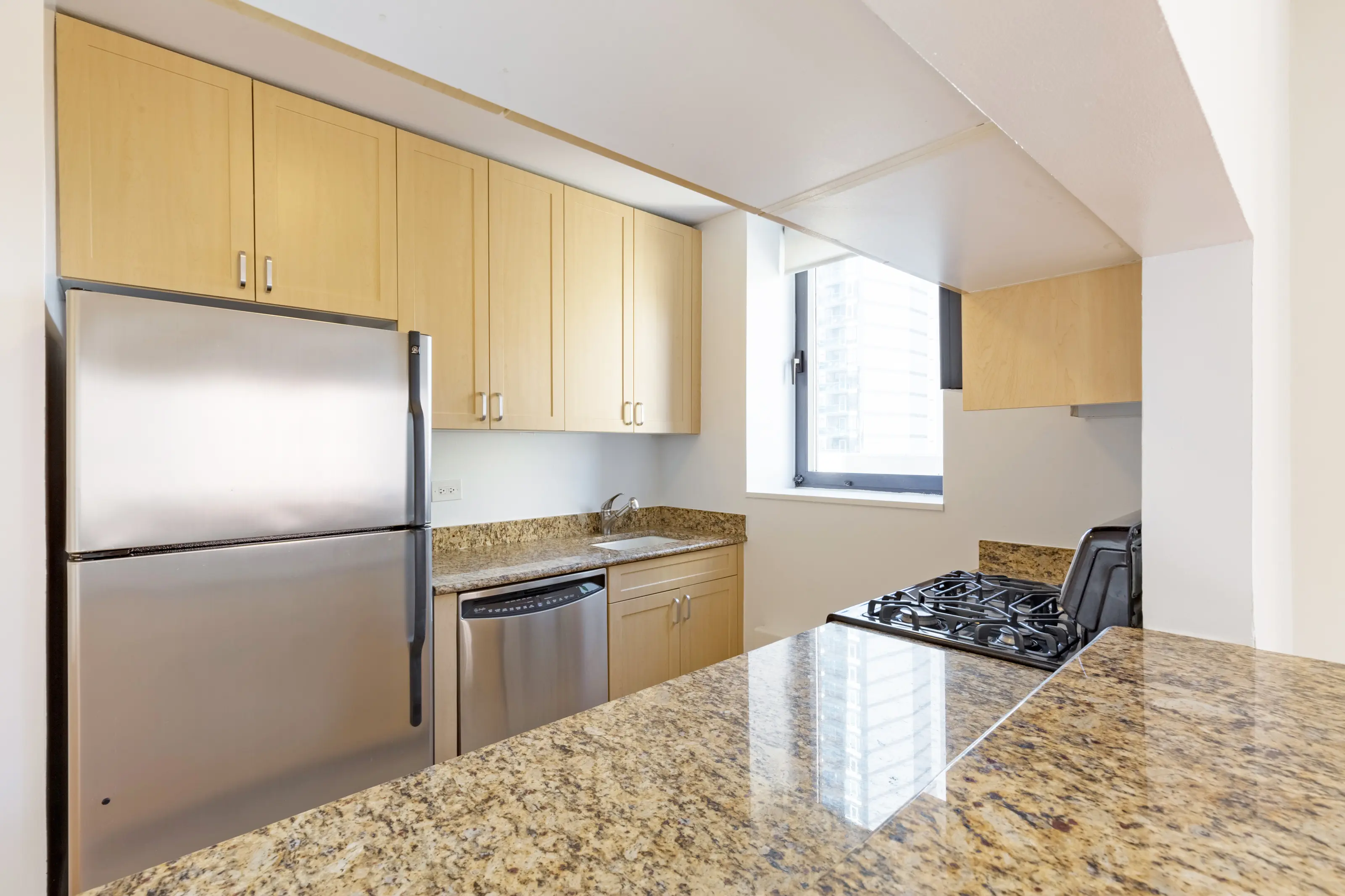 A modern kitchen featuring stainless steel appliances and elegant granite countertops.