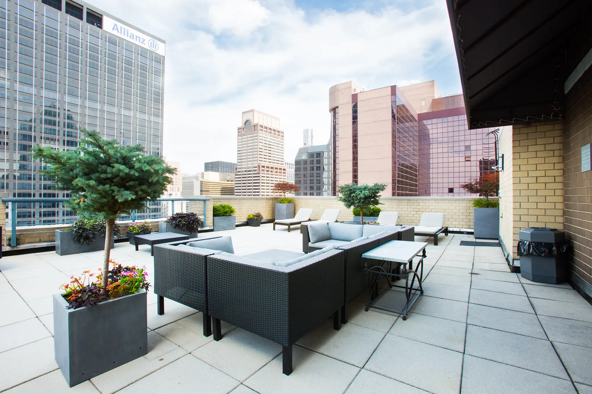  A patio featuring a table surrounded by chairs, ideal for outdoor dining and relaxation.