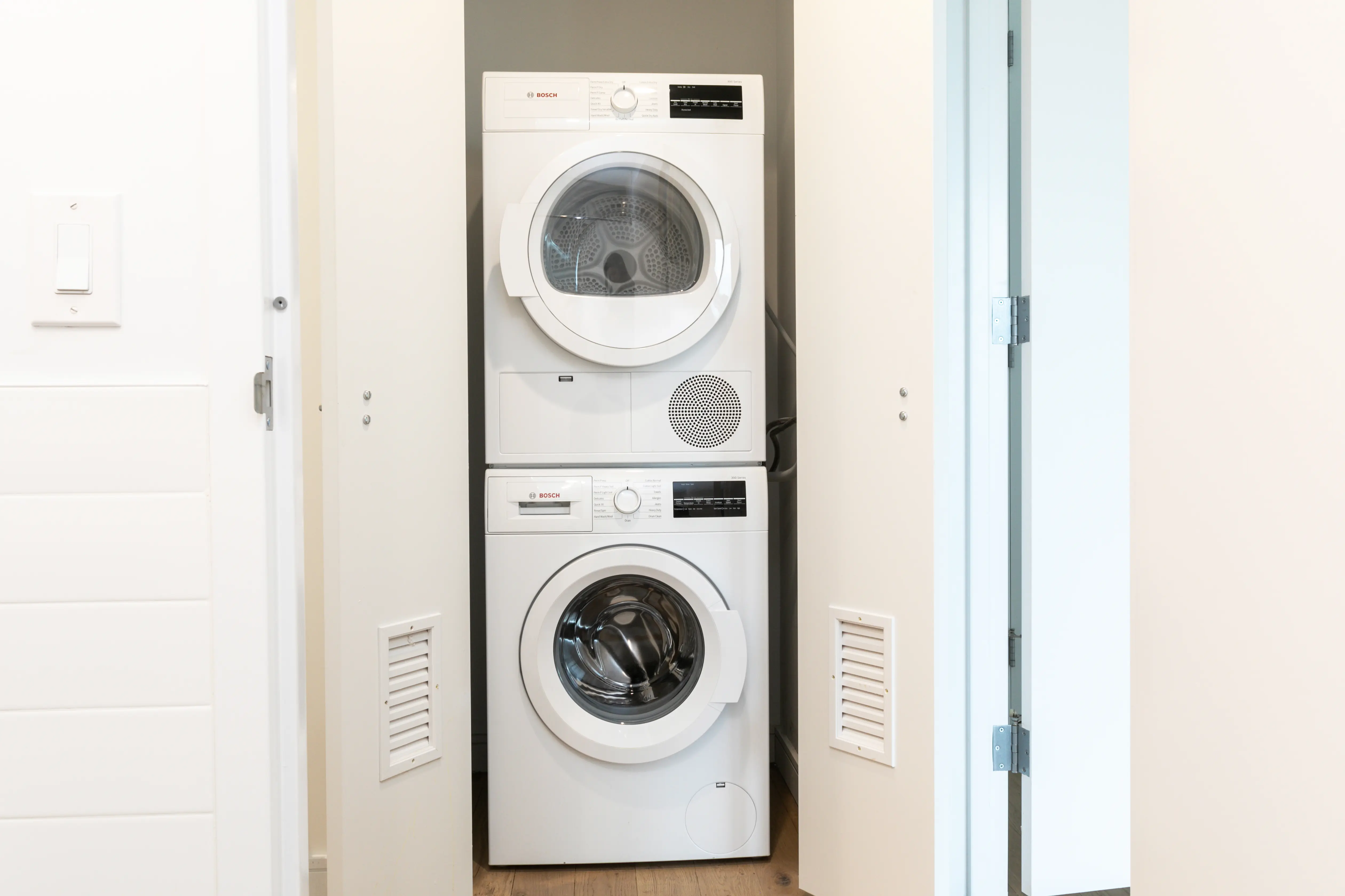 A compact washer and dryer set positioned in a small, functional laundry room.