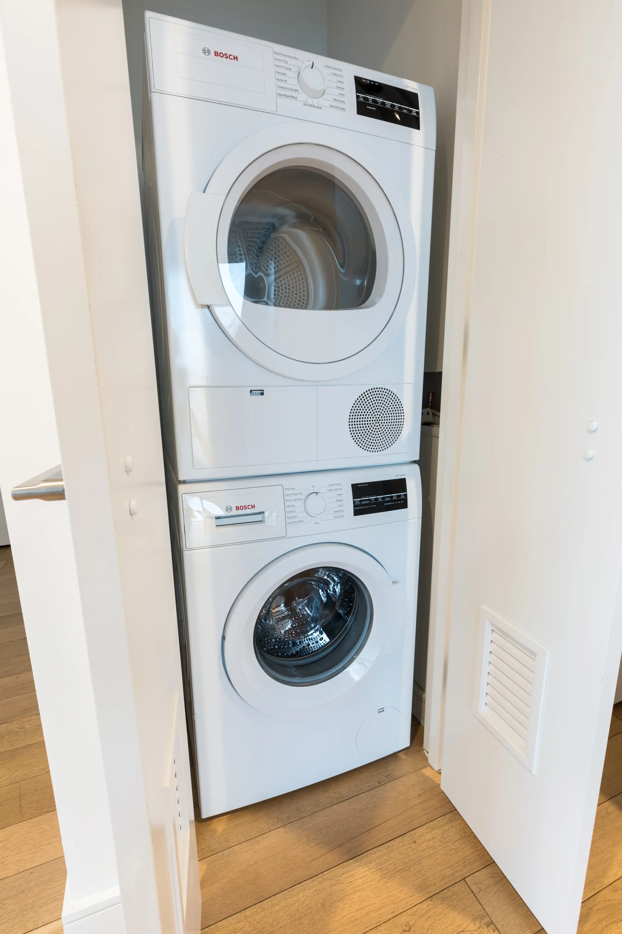 A compact washer and dryer set positioned in a small, functional laundry room.