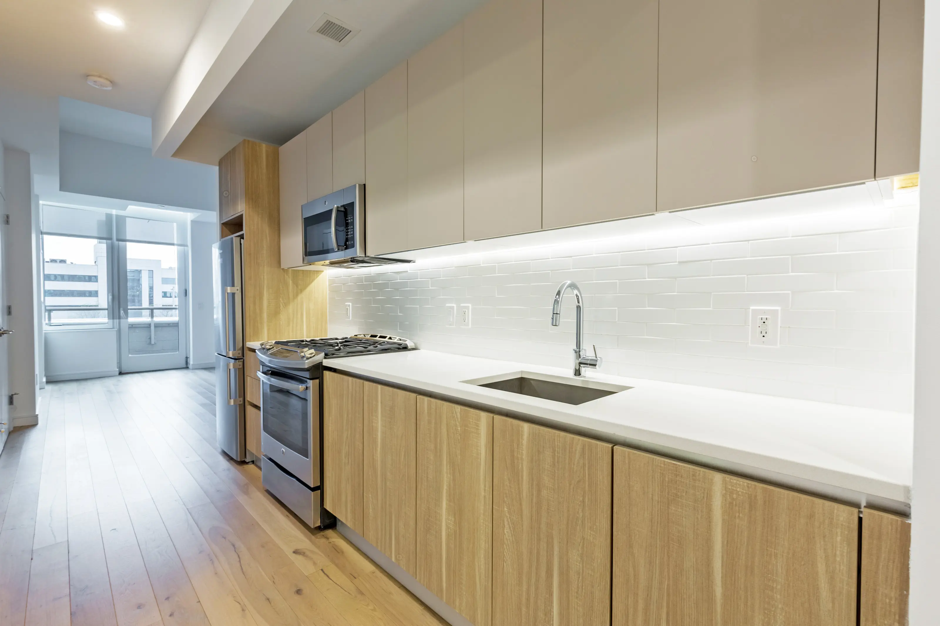 A kitchen featuring a sink, stove, and refrigerator, showcasing a functional cooking space.