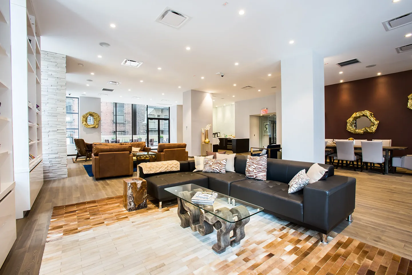 A stylish living room with sleek leather couches and a modern coffee table at the center.