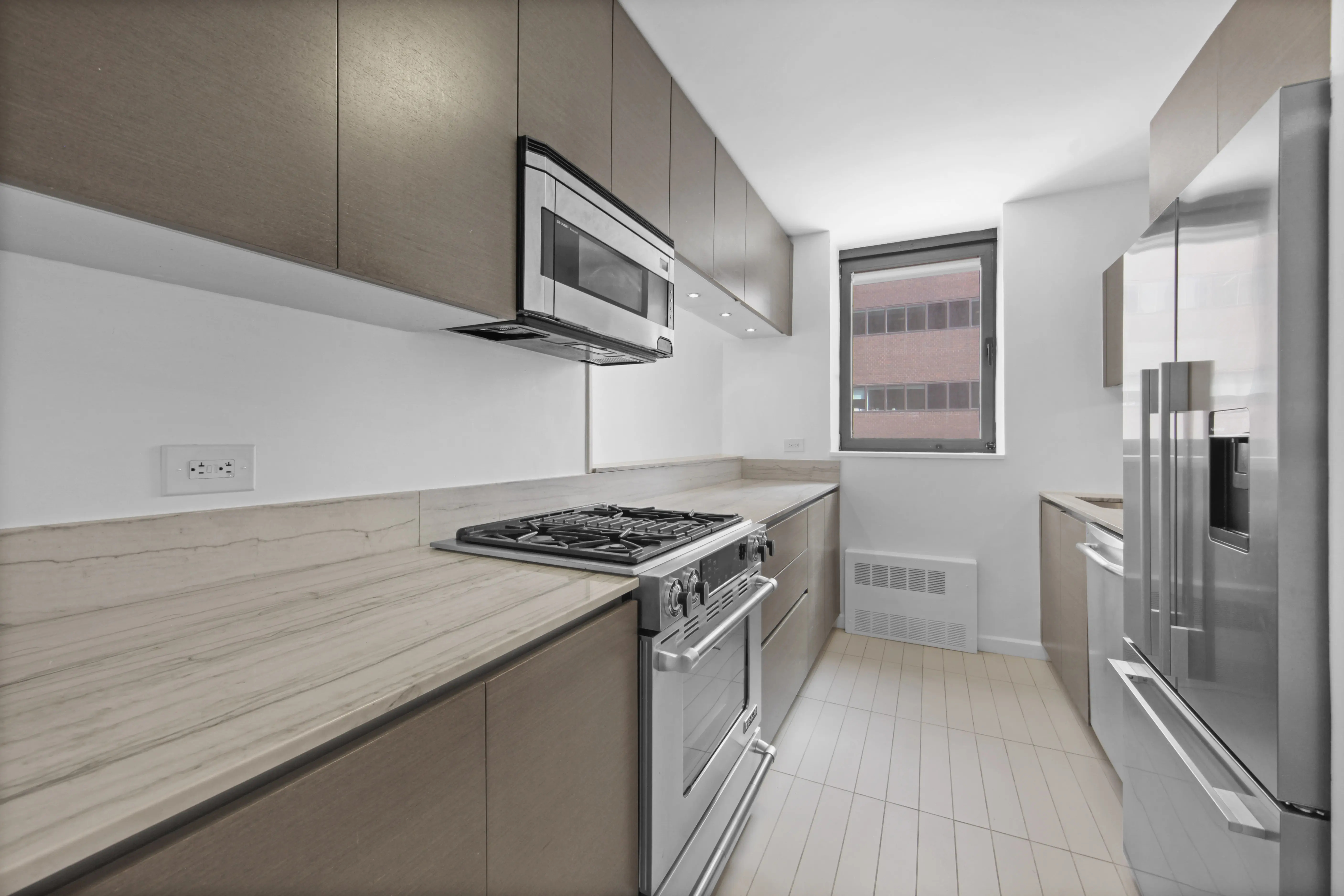 A modern kitchen featuring stainless steel appliances and elegant wood cabinets.