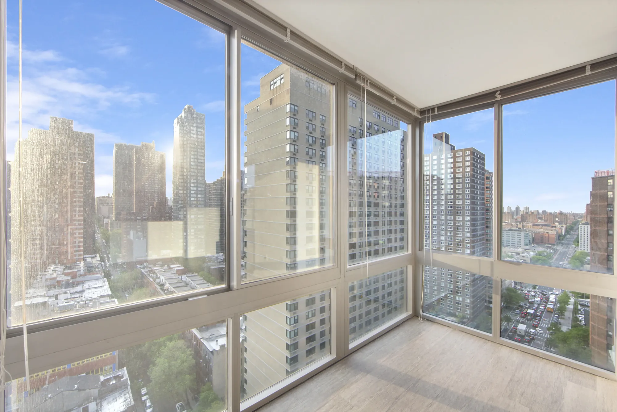 An airy apartment with large windows that provide a scenic view of the urban landscape.
