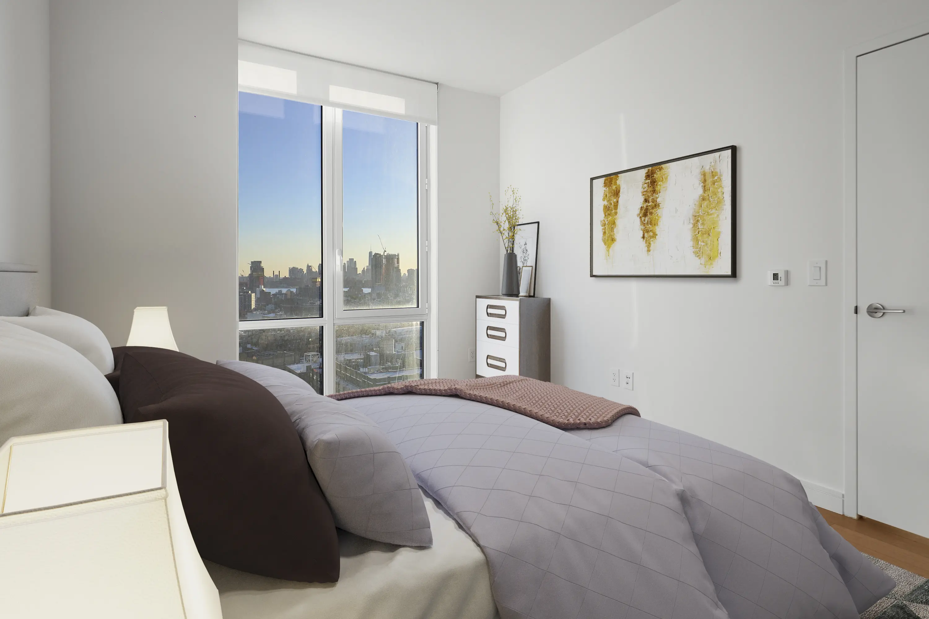 A stylish bedroom showcasing a panoramic view of the vibrant city skyline from its large window.