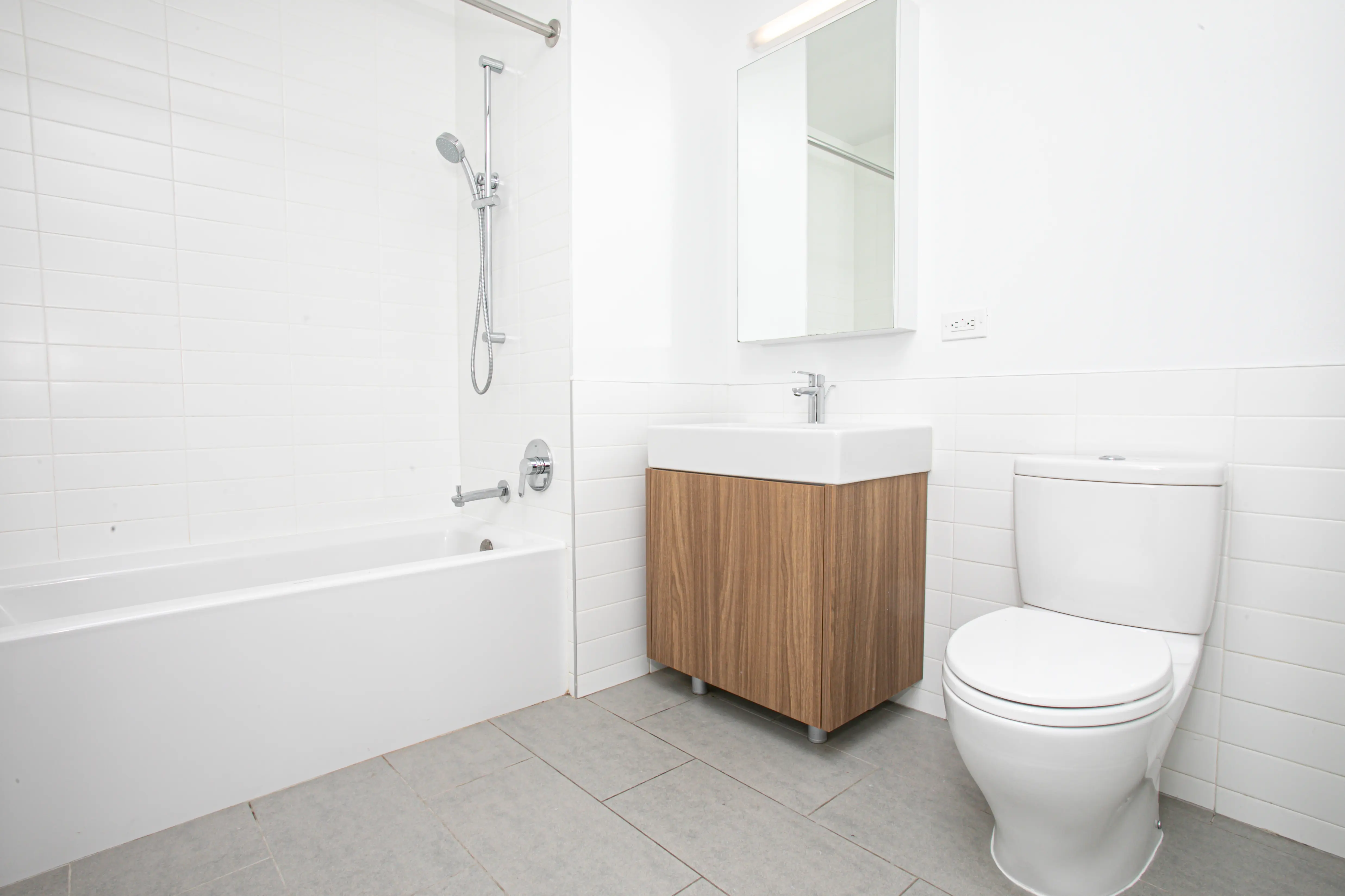A bathroom featuring a toilet, sink, and bathtub, designed for functional and comfortable use.