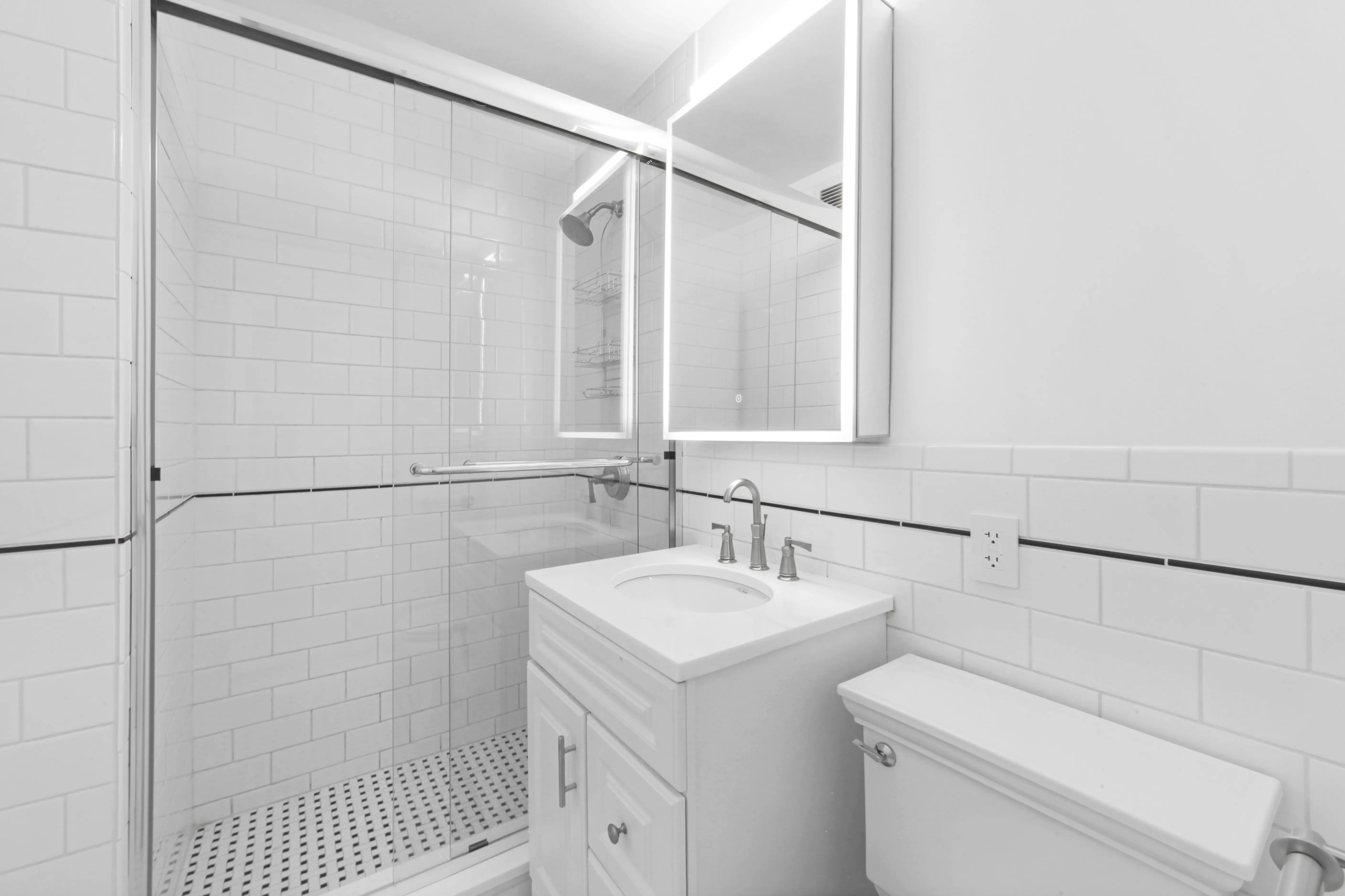 A bright white bathroom with a shower and toilet, emphasizing a fresh and tidy atmosphere.