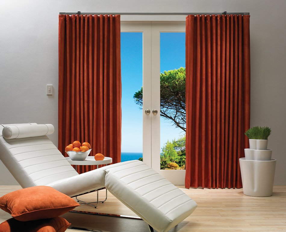 Living room with red drapery panels framing a patio door