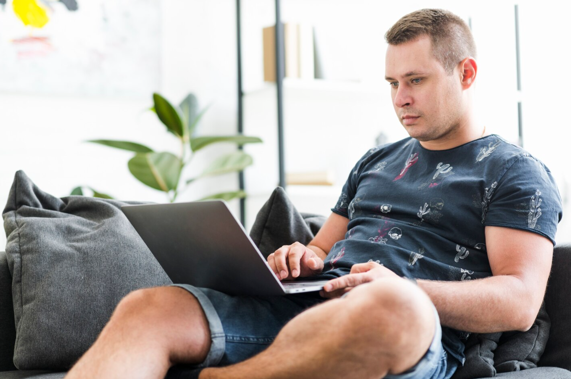 Man researching semaglutide weight loss clinics near him on a laptop