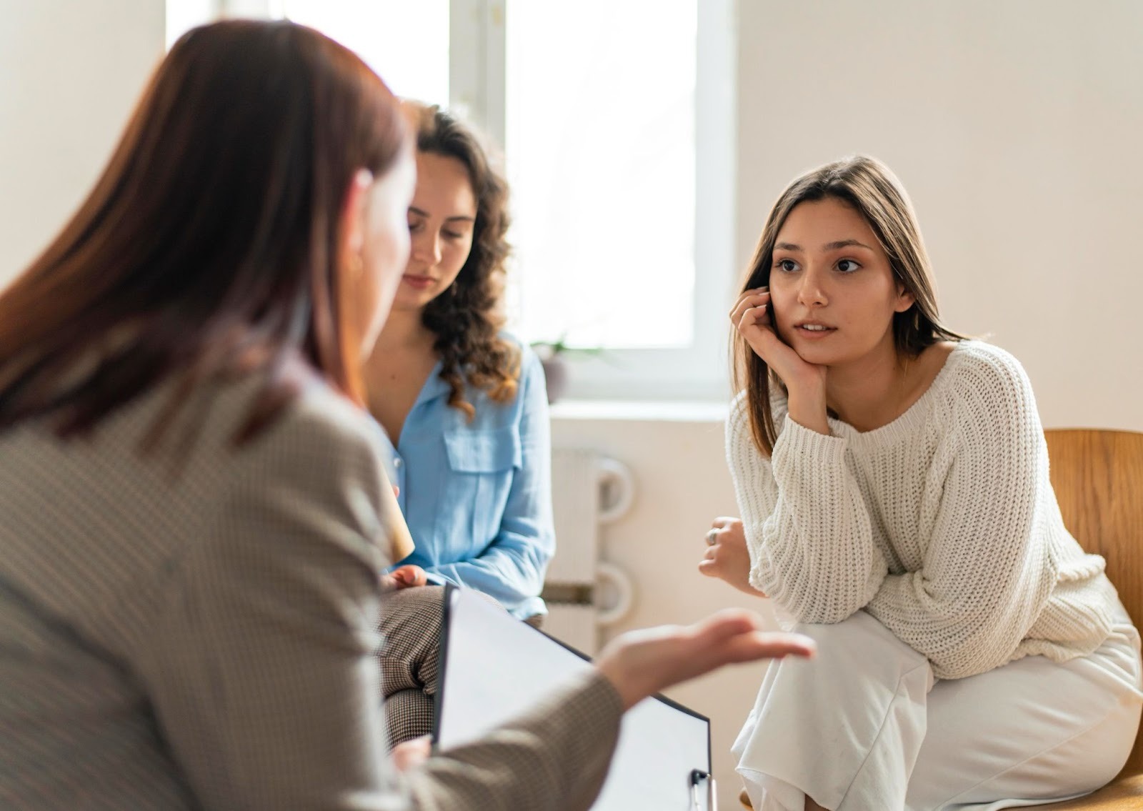 Three people in a therapy session