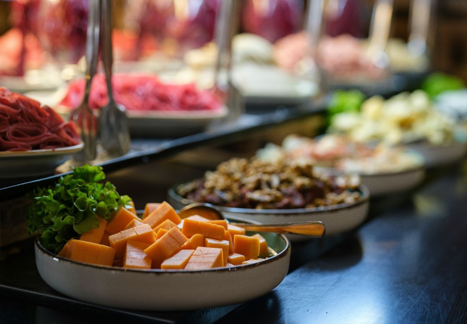 An array of food on the table, with fruits and vegetables on the foreground
