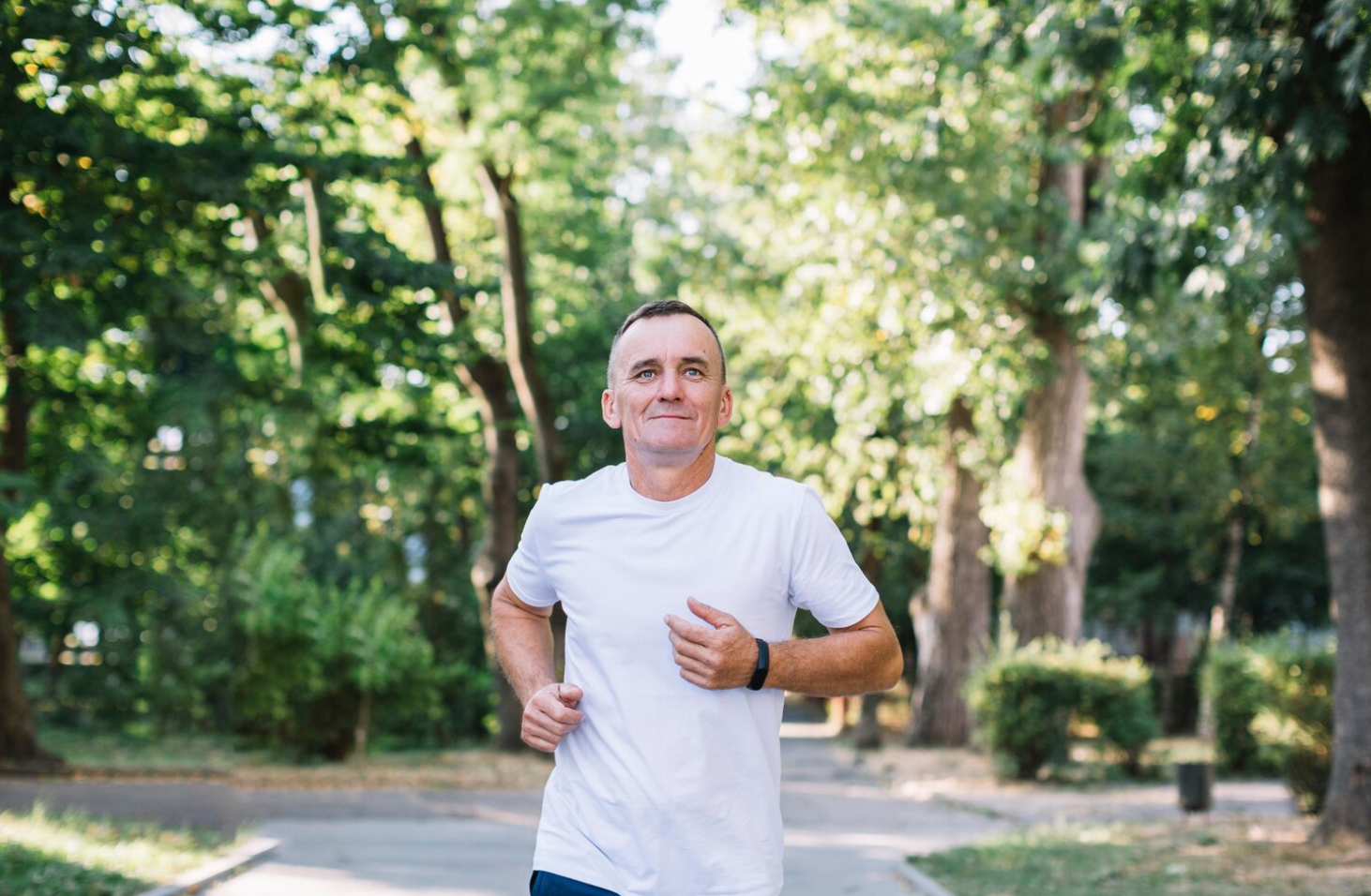 A man running in a park to complement his semaglutide weight loss program