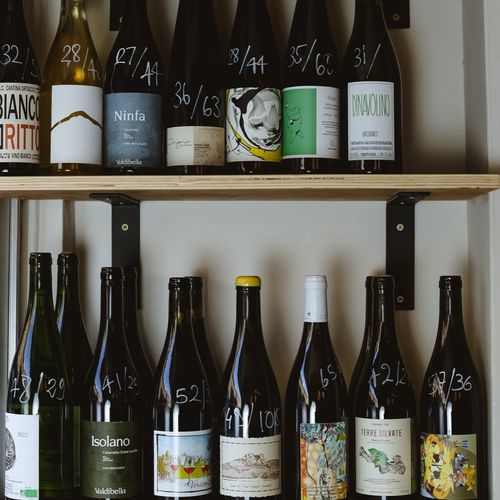 Natural wine bottles on the shelves inside Giacco's wine bar