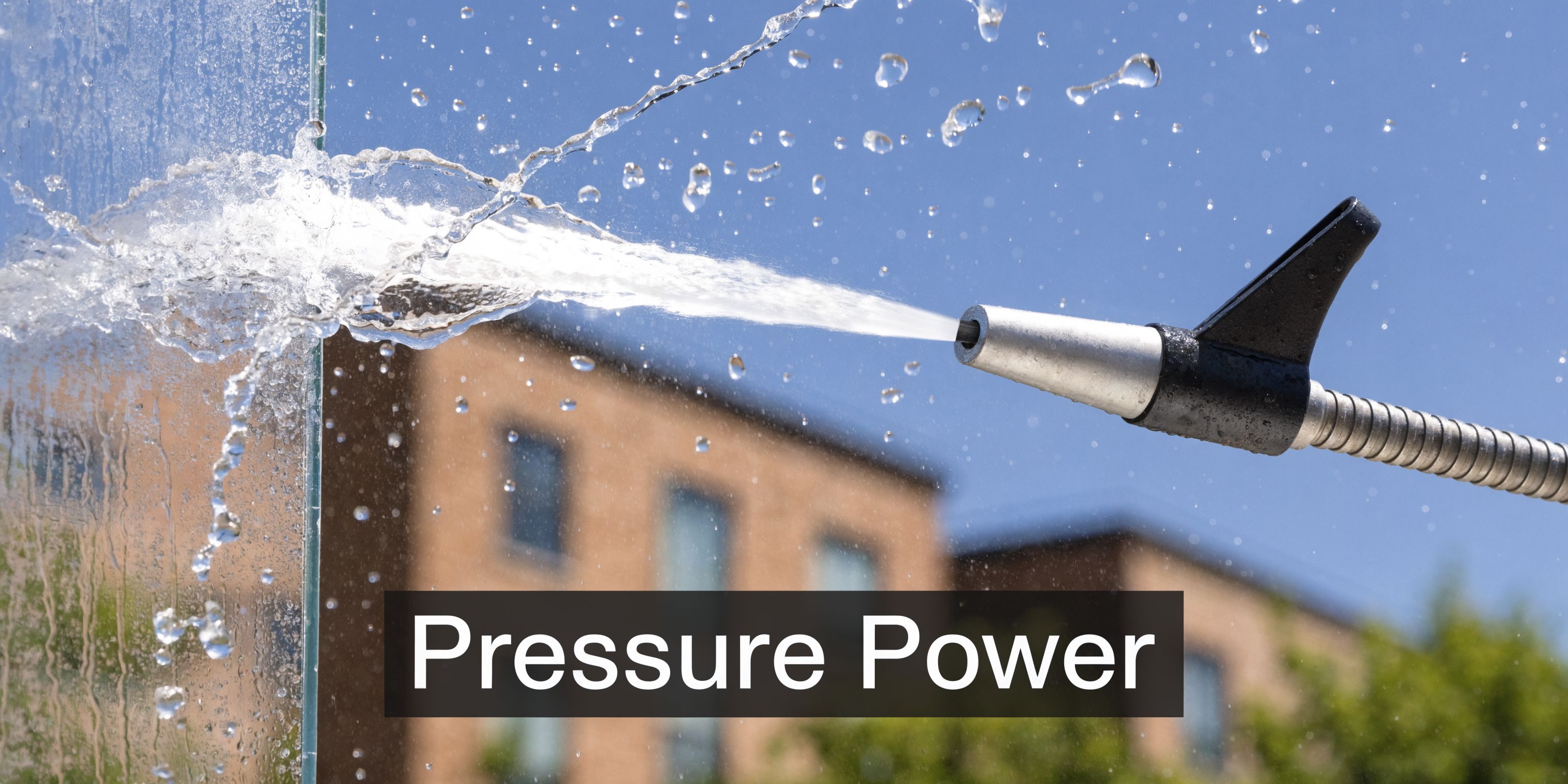 A pressure washer nozzle sprays a powerful stream of water against a glass window for deep cleaning.