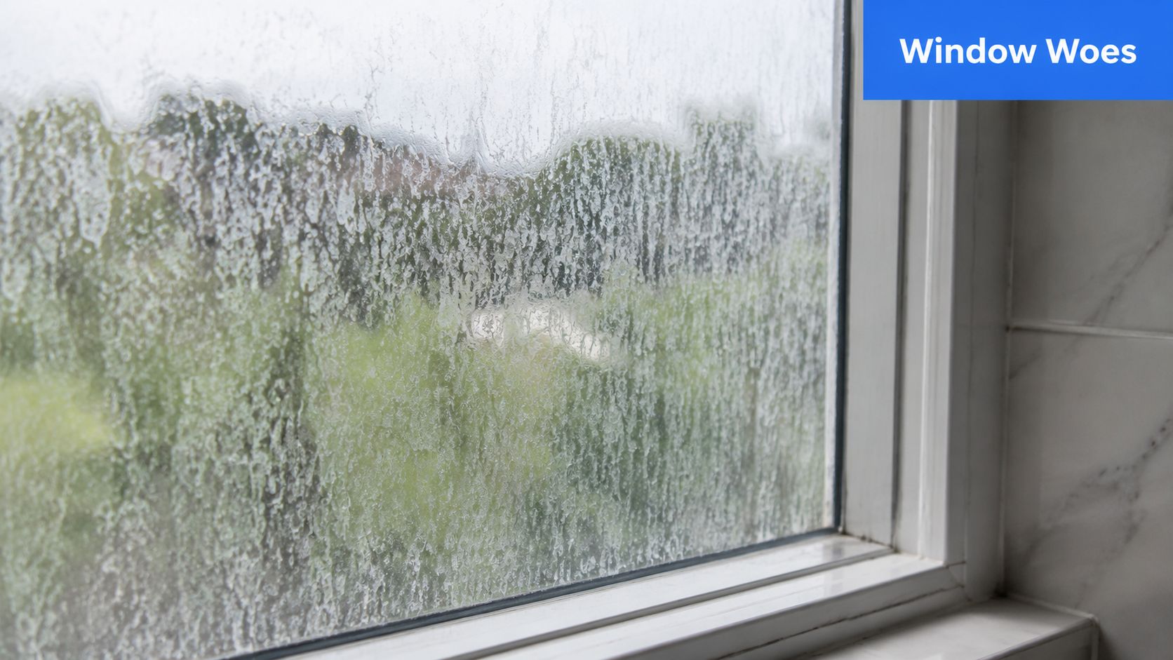 A close-up view of a glass window covered in heavy white mineral deposits and hard water stains.