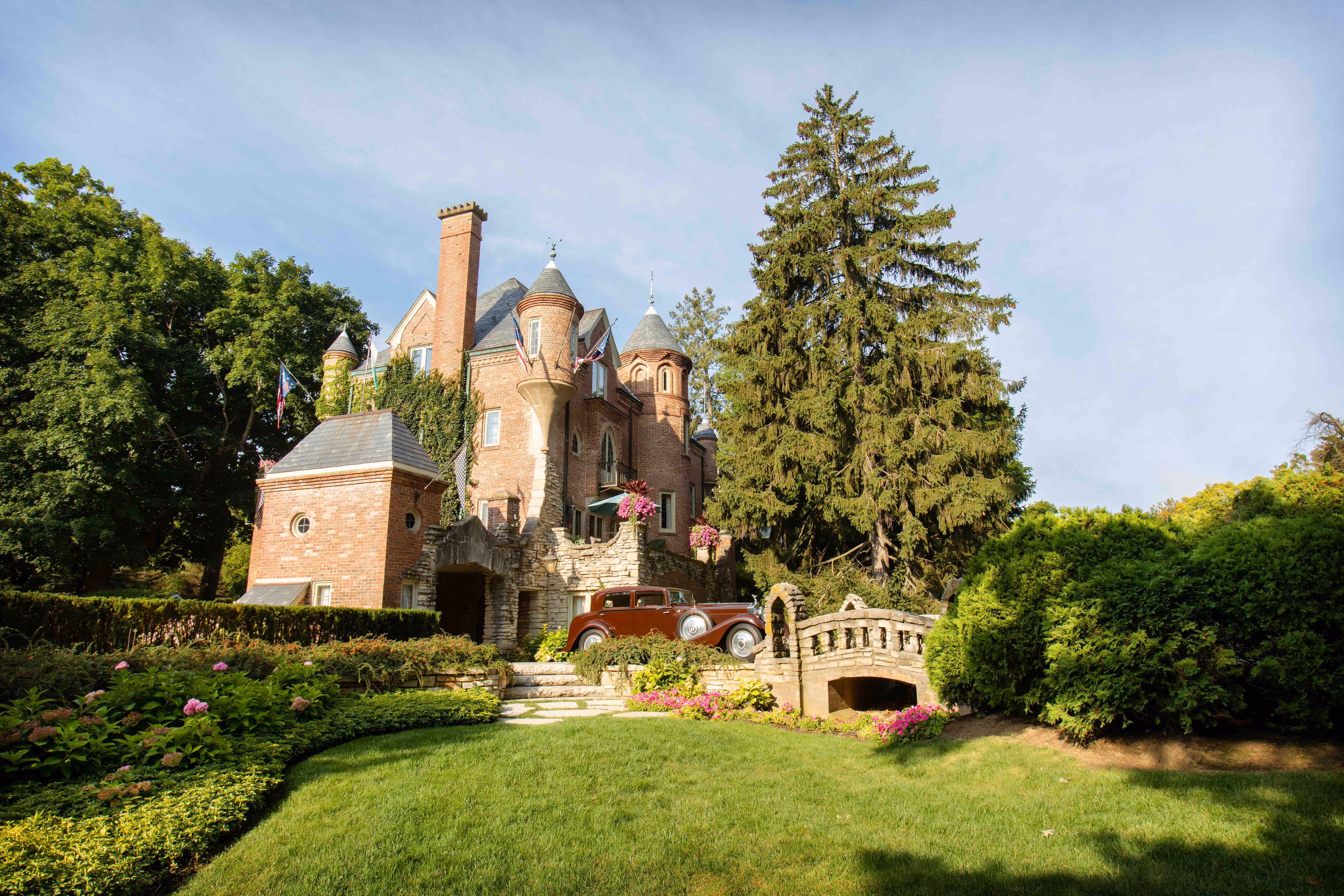 A wide shot of the Soderstrom Castle featuring the bridge, a red car from Dr. Soderstrom's collection, and the beautiful lawn.