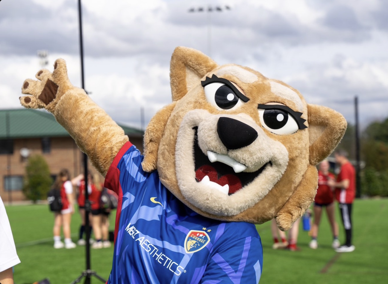 North Carolina Courage mascot celebrating with fans at a match