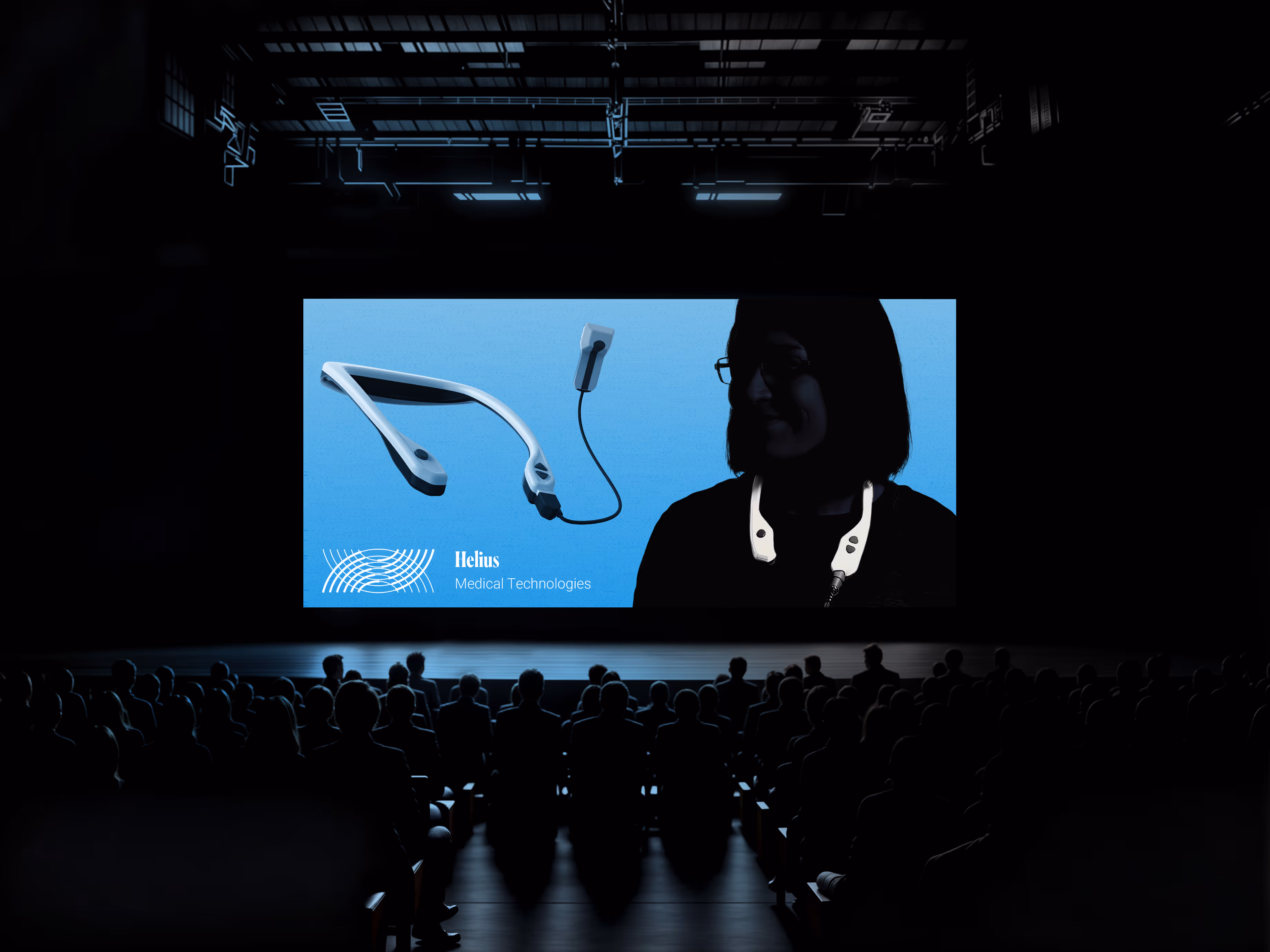 Audience seated in a dark auditorium watching a large screen presentation of Helius Medical Technologies. The screen displays the PoNS™ neurostimulation device alongside a silhouetted patient wearing the device. The blue background and branding highlight Helius’s innovations in neurotech therapy and rehabilitation solutions.