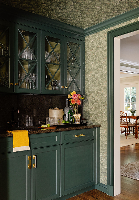 Carriage House designed by PBF Homes with stunning accent floral wallpaper and a pristine bar 