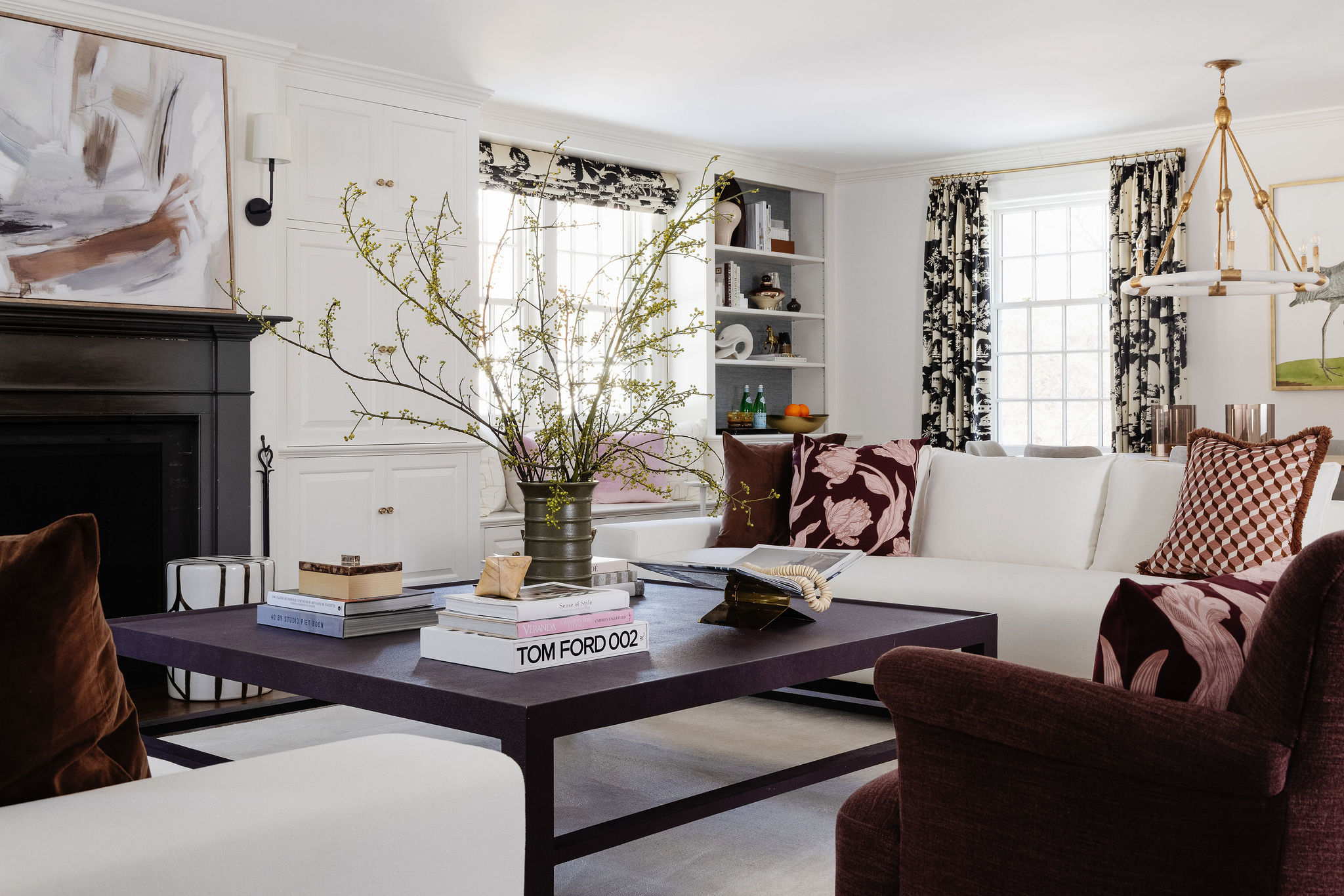 Expansive living room with modern furniture, accessories, and plum-colored rug