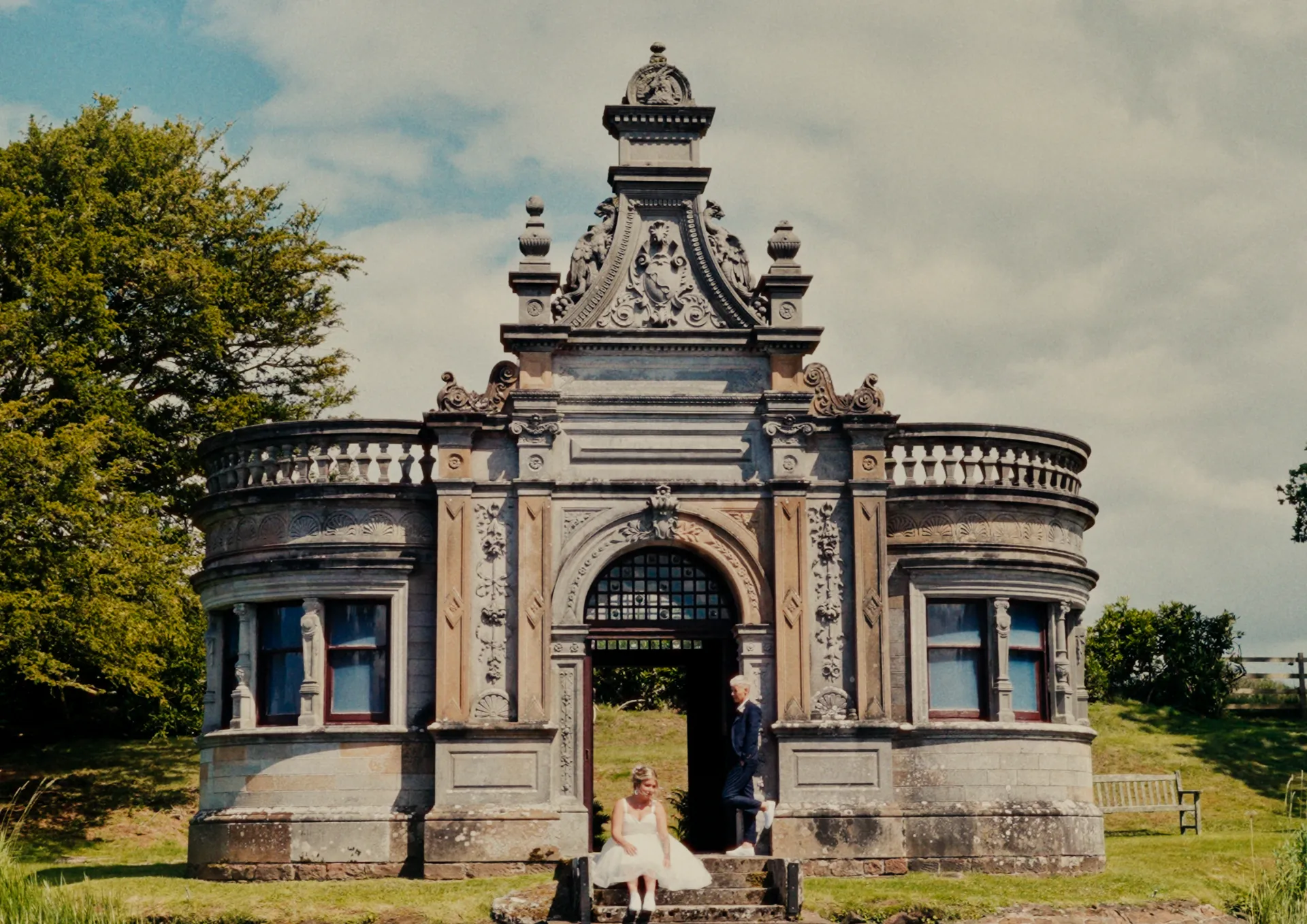 A couple on the steps of a stone folly
