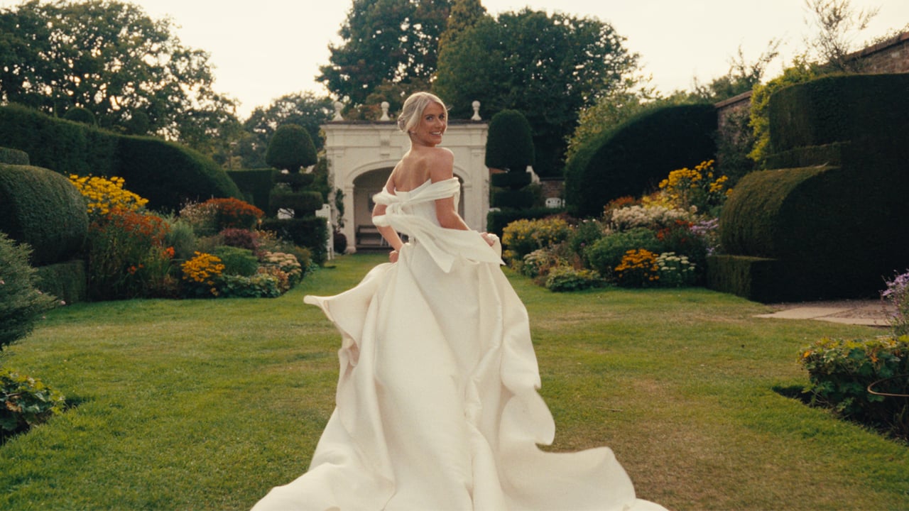 A bride walking through the gardens at Arley Hall