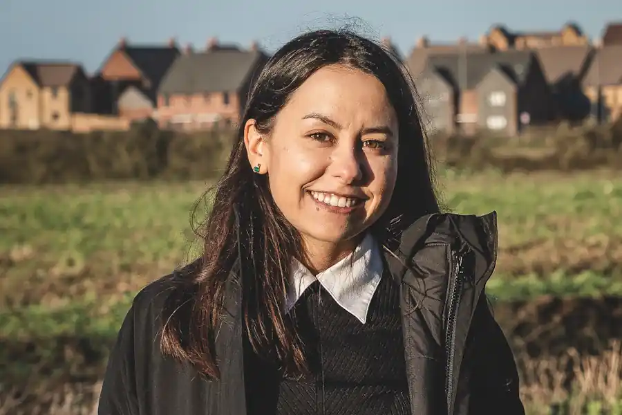 Grace Pinault in a field beside new housing in Kent