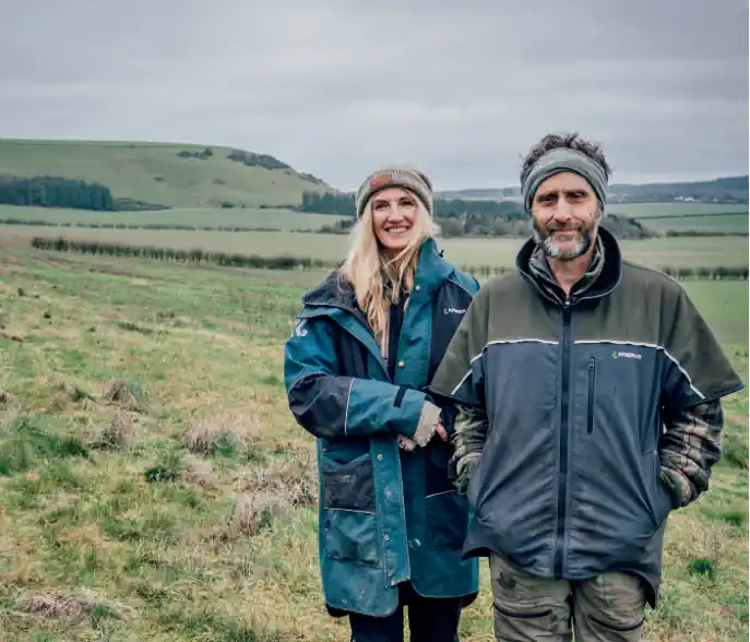 Sonja and Perin Dineley standing in a field at Red House Farm, Wiltshire