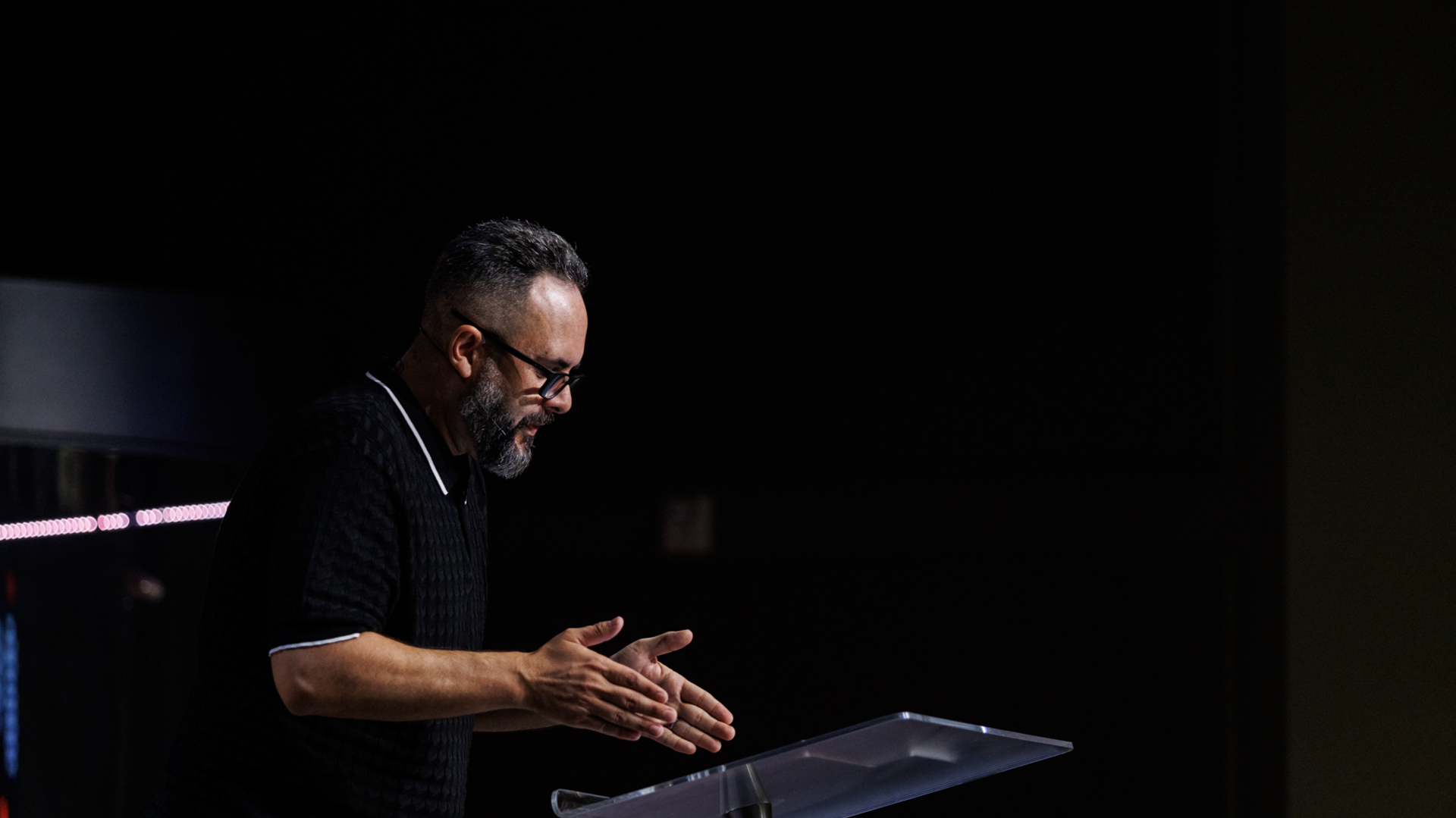A pastor preaching from a platform