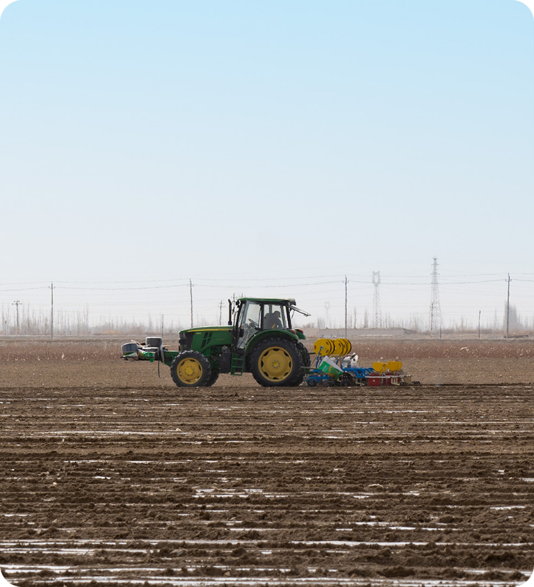 Tractor working on a plowed field