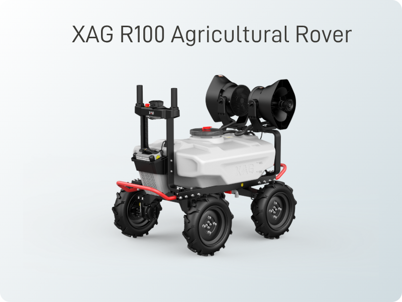 XAG R100 agricultural rover with four large wheels, white tank, and dual black sprayers.