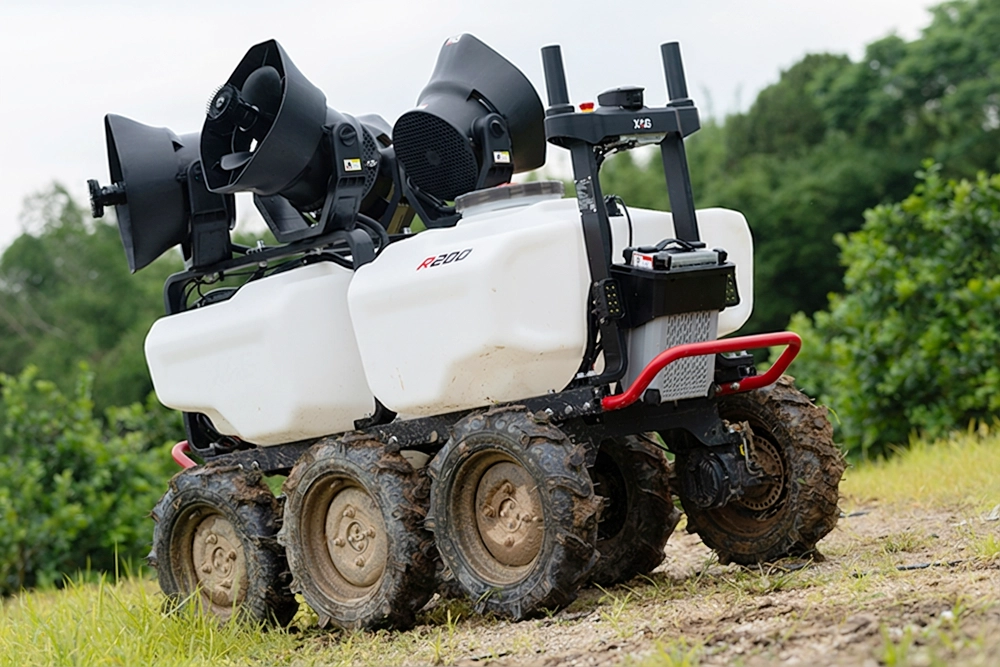 Six-wheeled white agricultural robot with sprayers on uneven grassy terrain