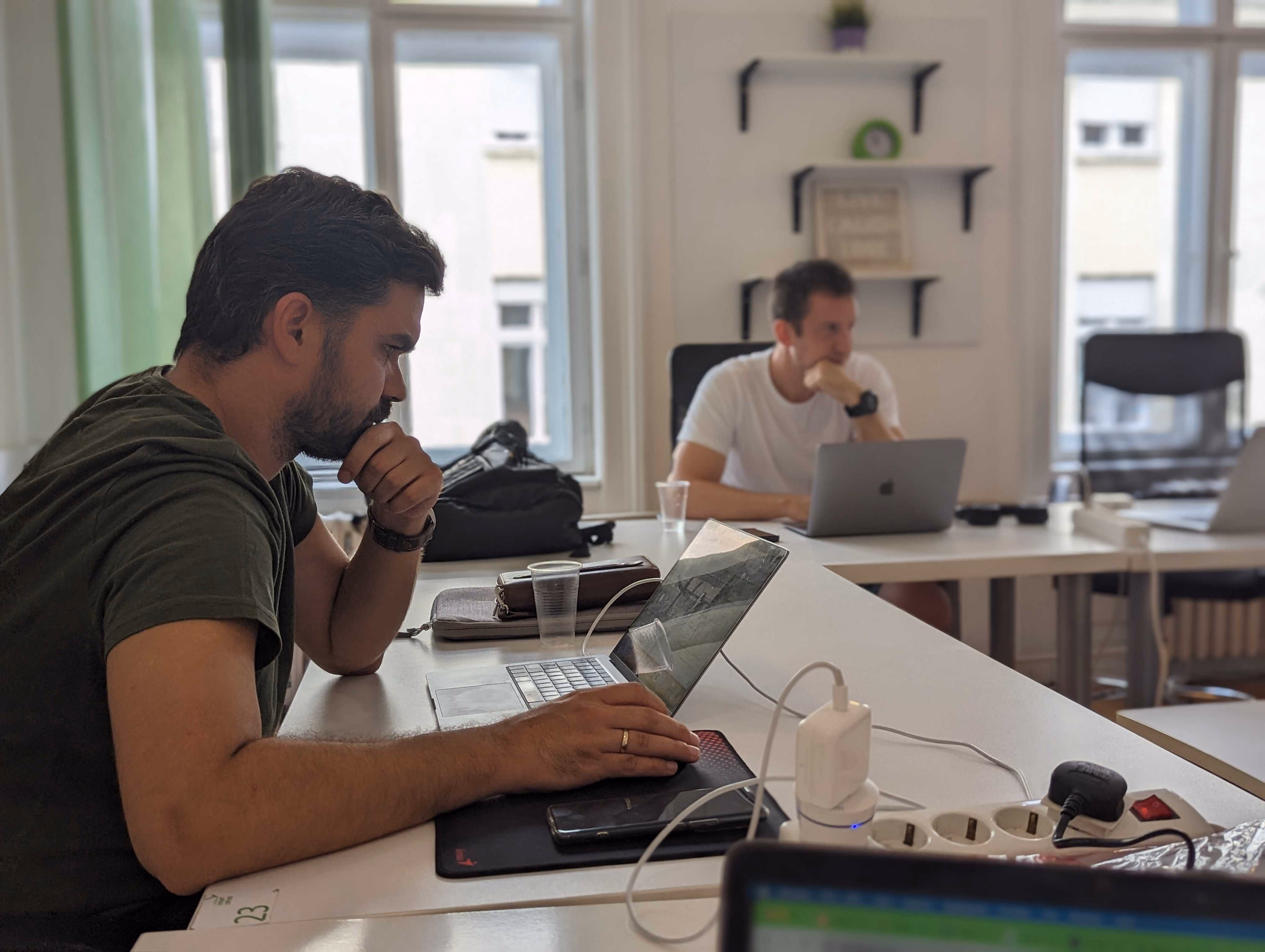 FWRD Digital team member focused on working at a laptop in a bright, modern office environment.