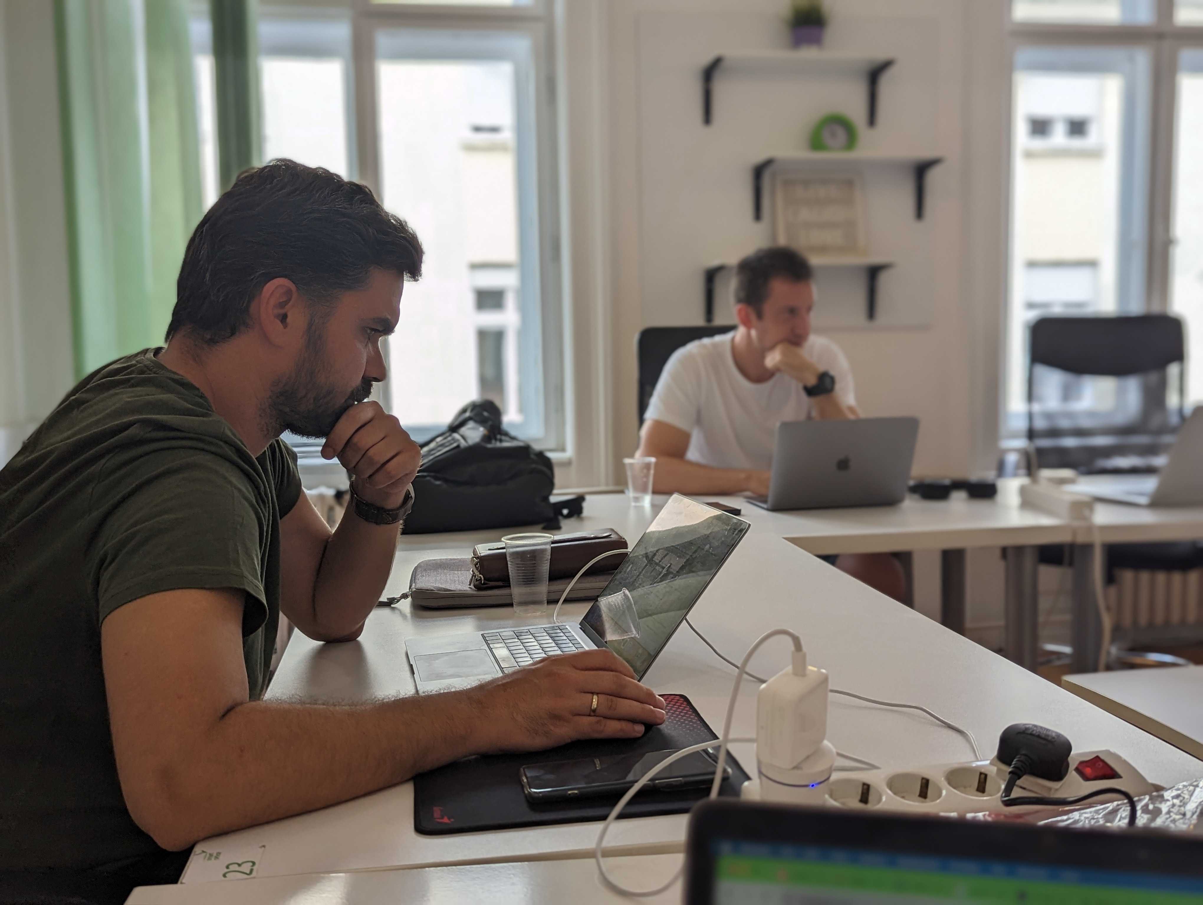 FWRD Digital team member focused on working at a laptop in a bright, modern office environment.