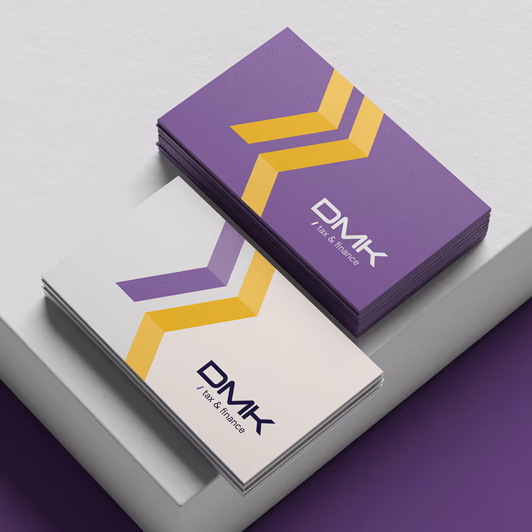 Branding mockup of DMK Tax & Finance business cards in purple and white color schemes with angled yellow accent stripe.
