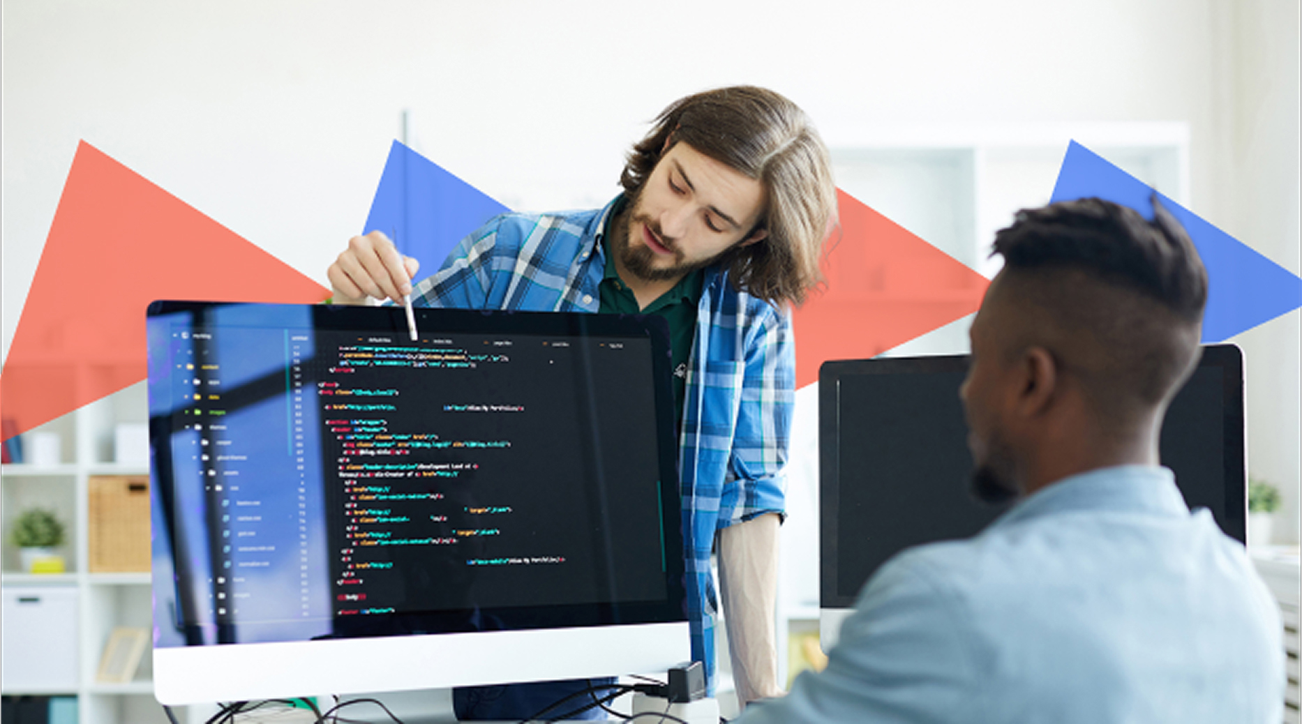 Web developer presenting website code to a client in a creative agency workspace, discussing front-end structure.
