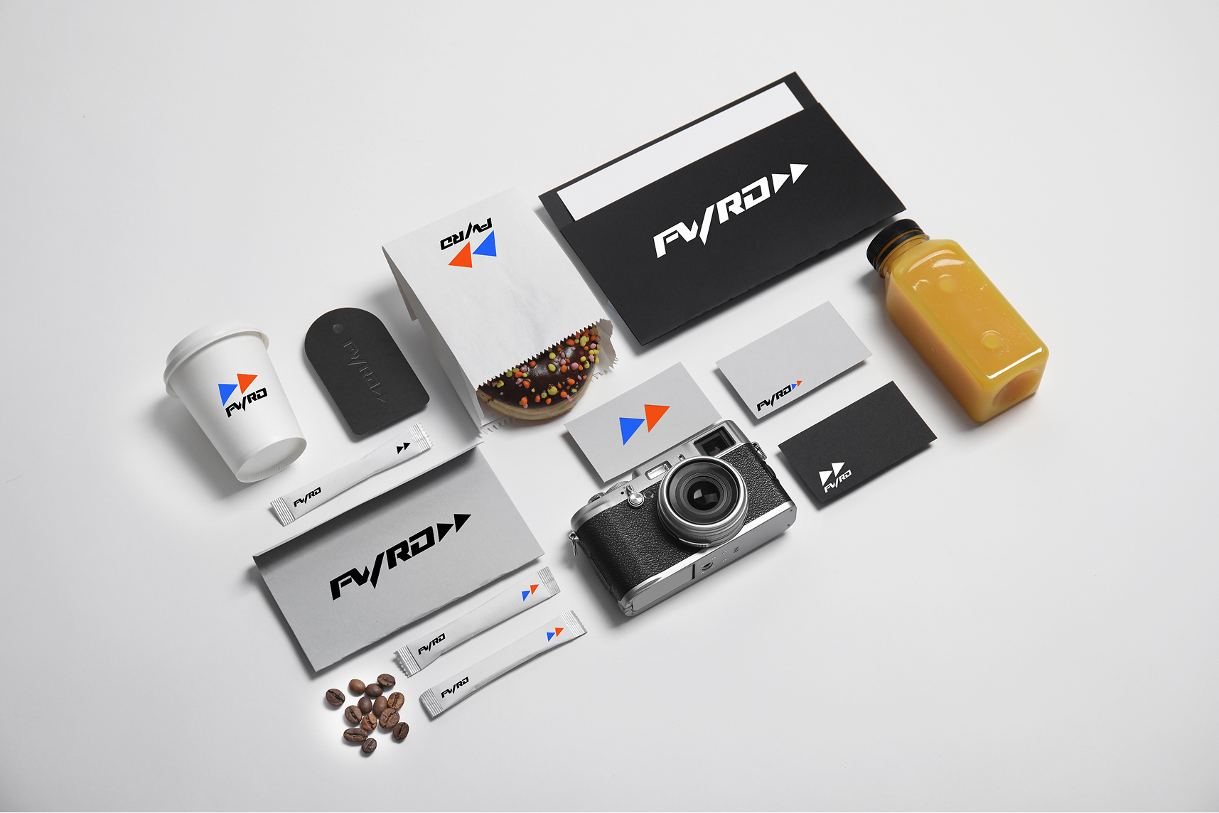 Full visual identity system layout featuring branded packaging, business cards, and merchandise with consistent design elements.