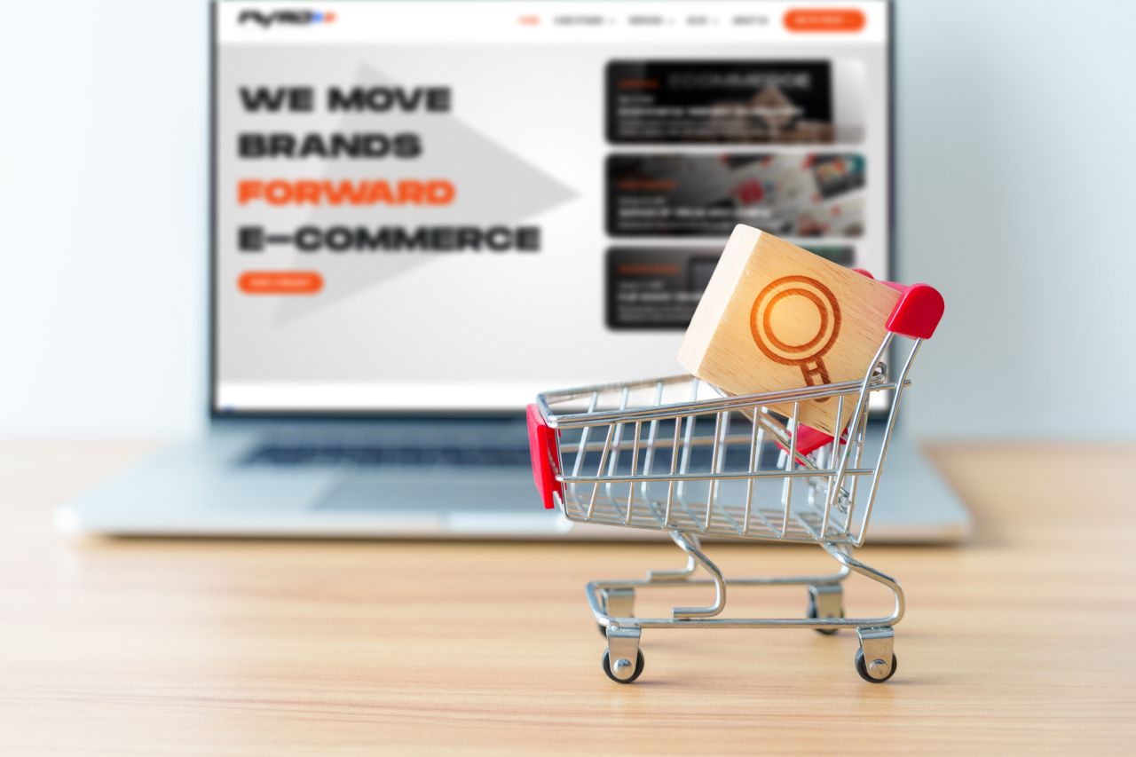 Mini shopping cart with colorful bags on a laptop, symbolizing ecommerce structure, user engagement, and checkout experience.